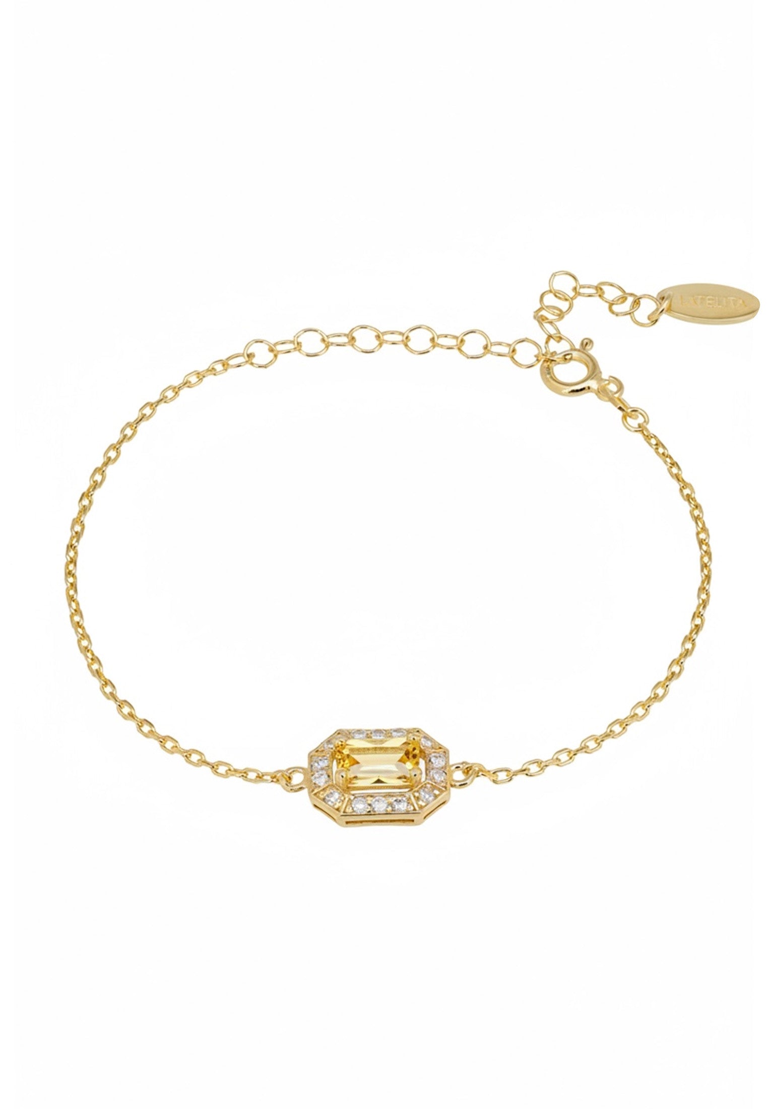 Gold bracelet with a green gemstone on a white background