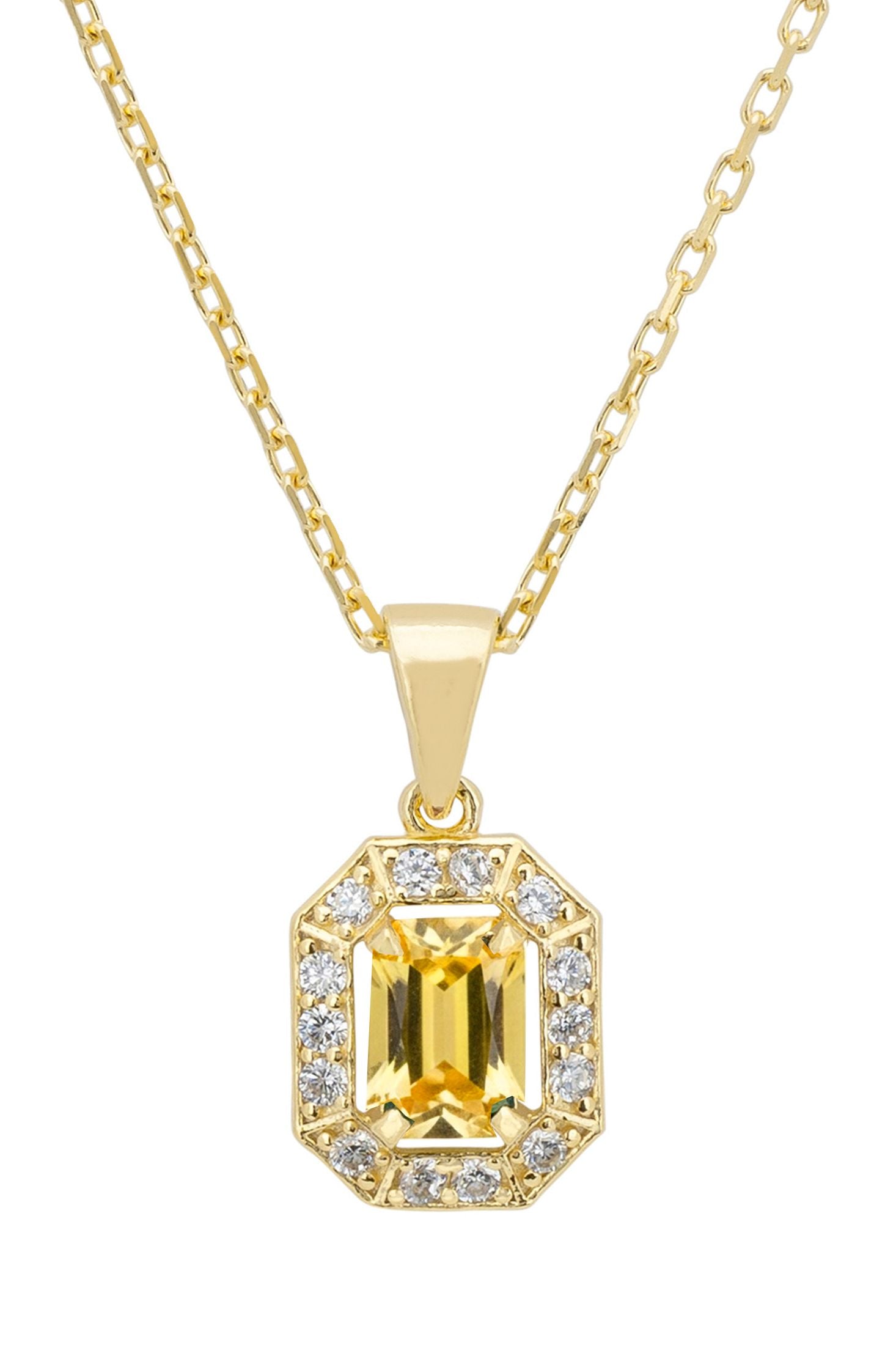 Gold necklace with a yellow gemstone pendant on a white background