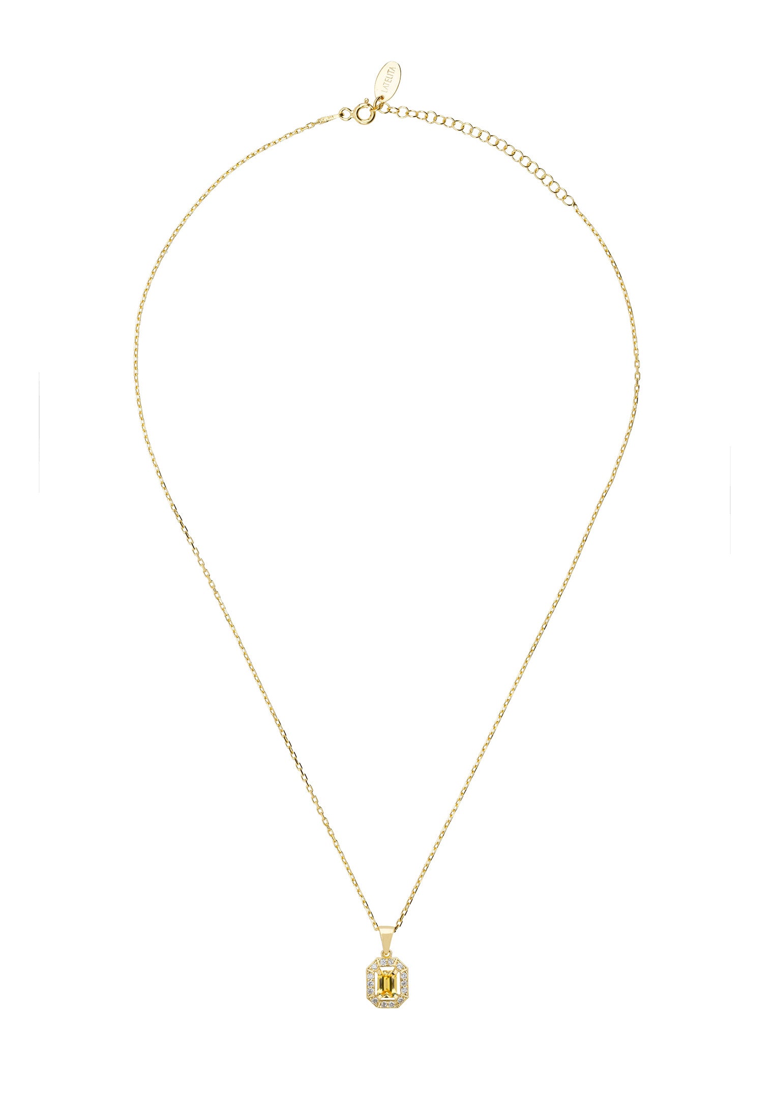 Gold necklace with a green gemstone pendant on a white background