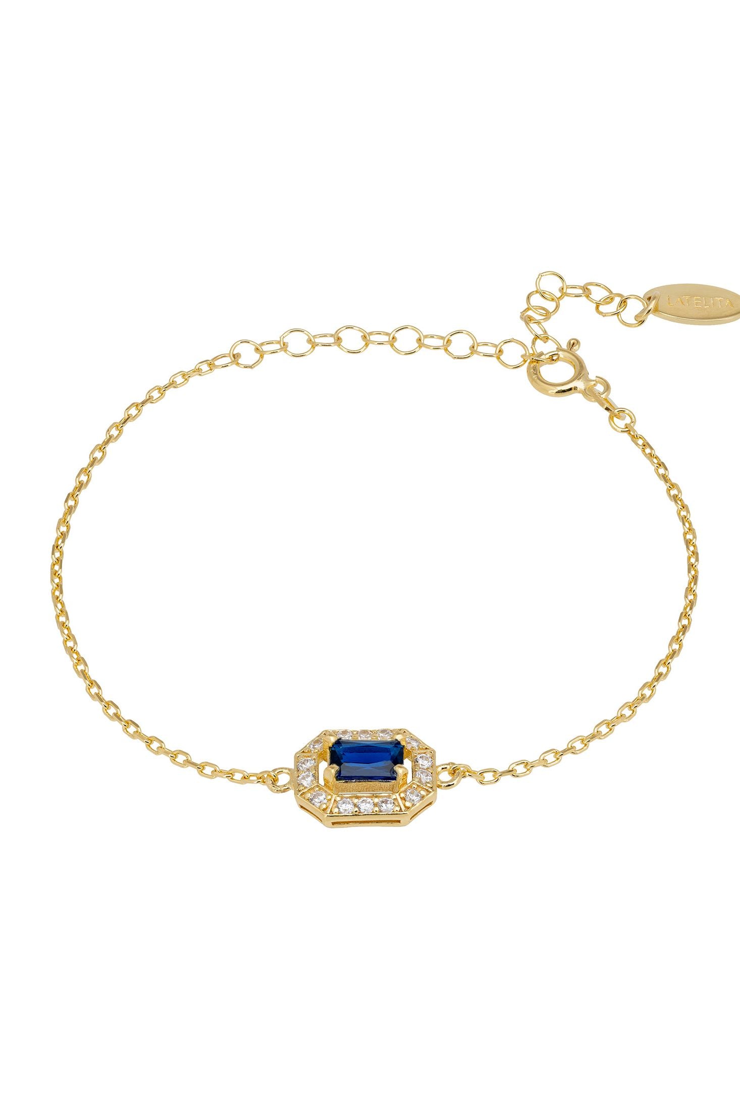 Gold bracelet with a blue gemstone on a white background