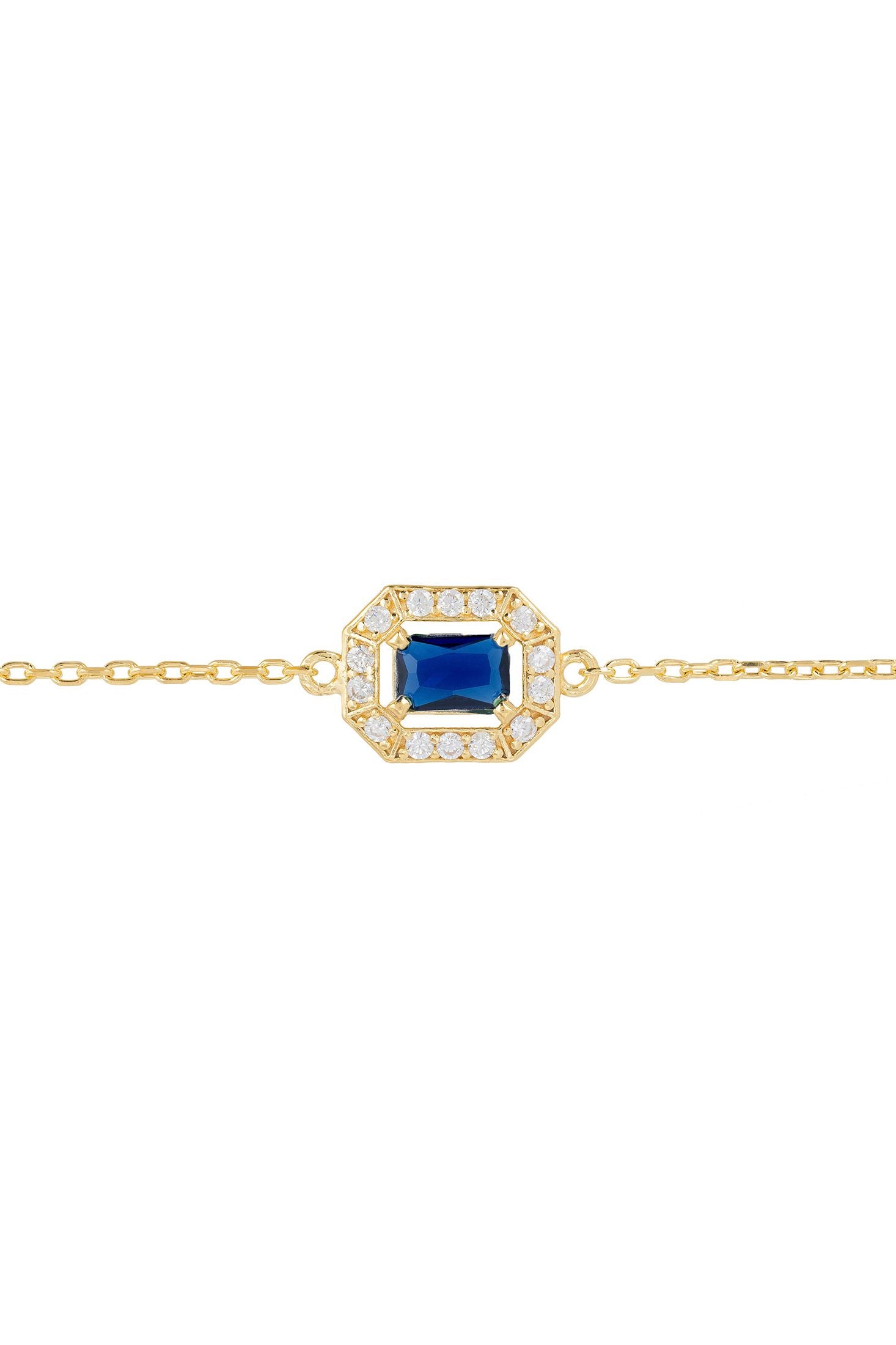 Gold bracelet with a blue gemstone and diamond accents on a white background