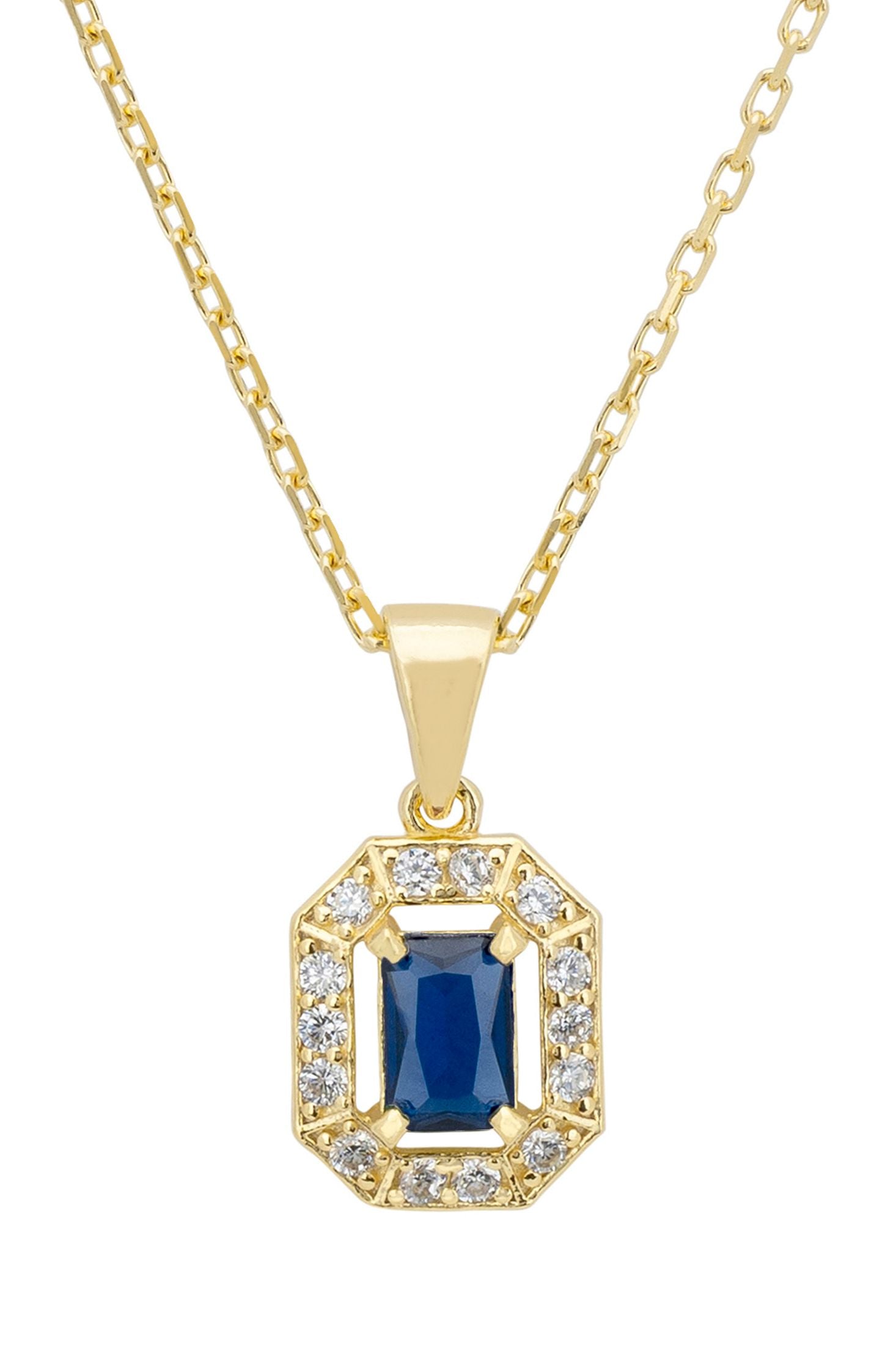 Gold pendant necklace with a blue gemstone and clear stones on a white background