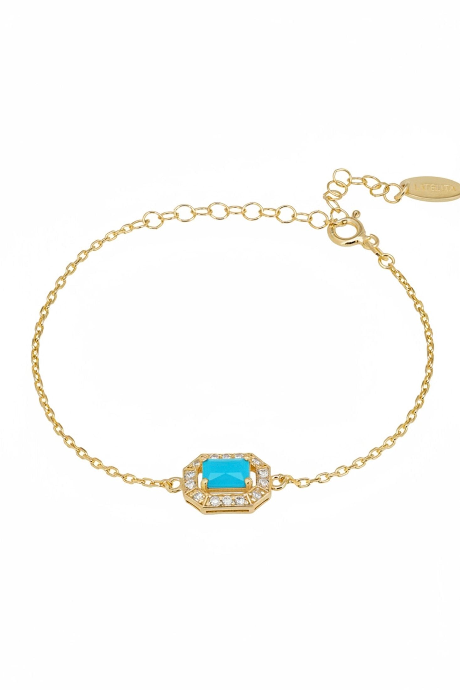 Gold bracelet with a turquoise stone on a white background
