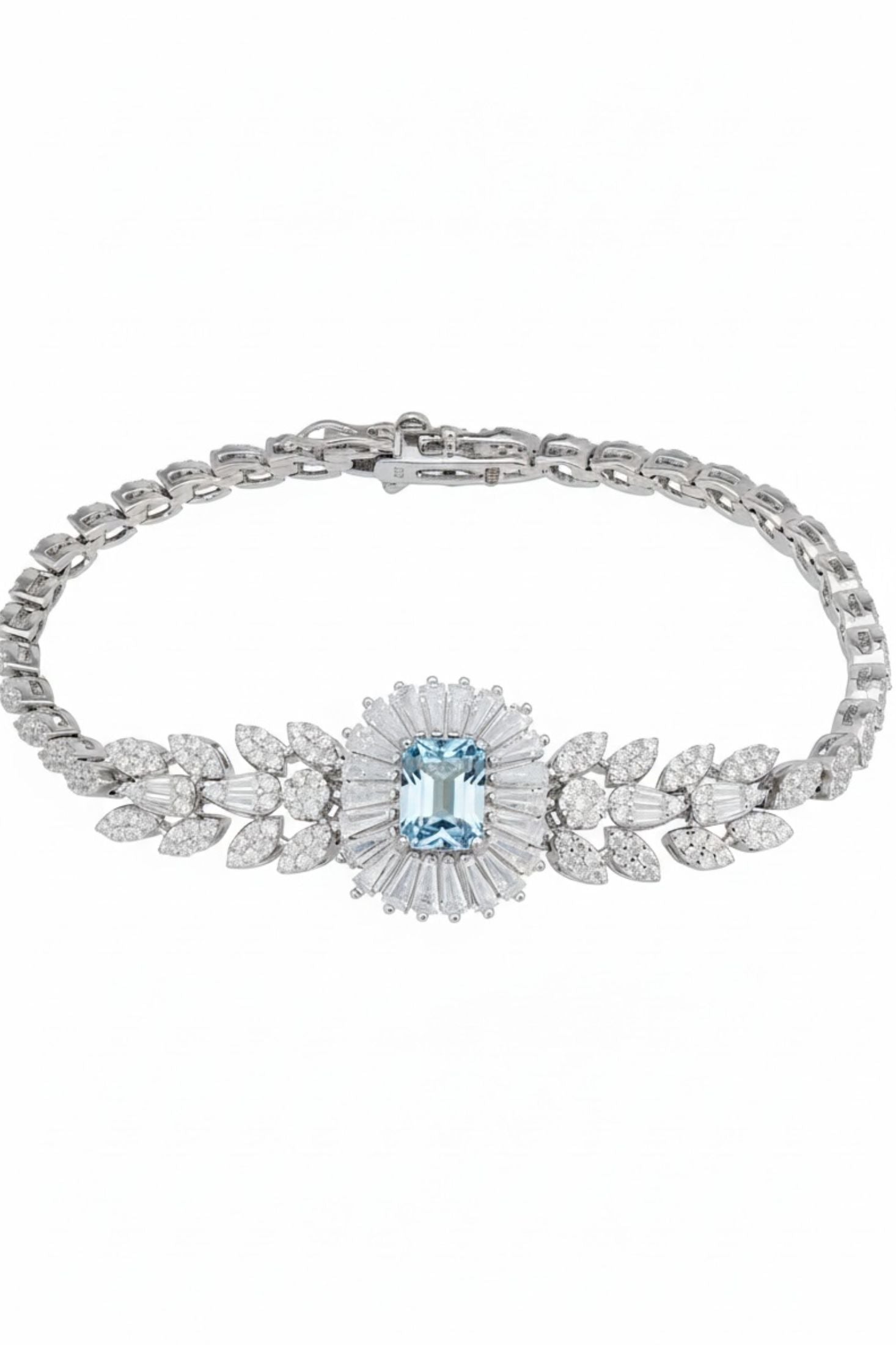 Silver bracelet with a central blue gemstone and floral design on a white background