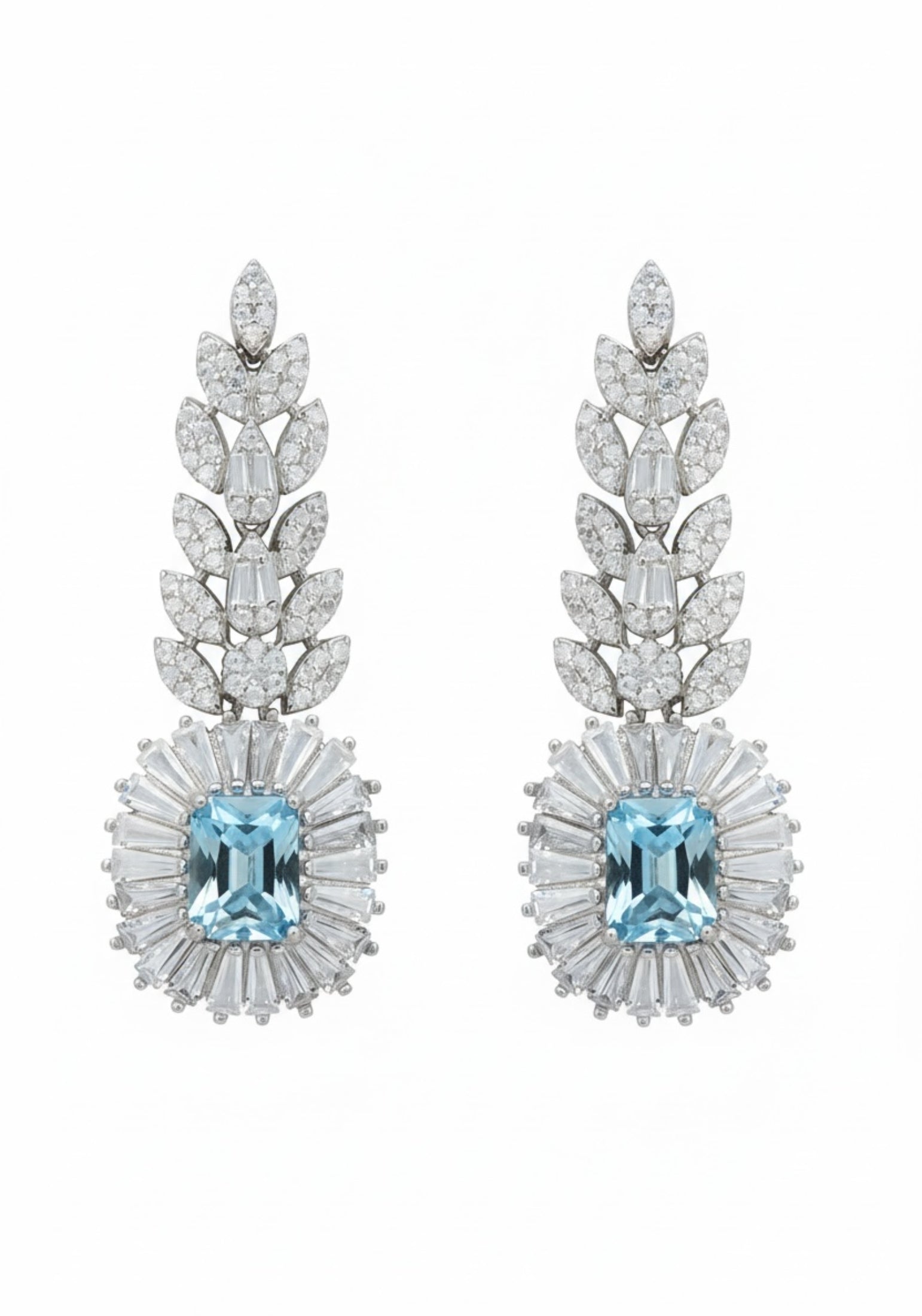Pair of earrings with blue gemstones and diamond-studded designs on a white background