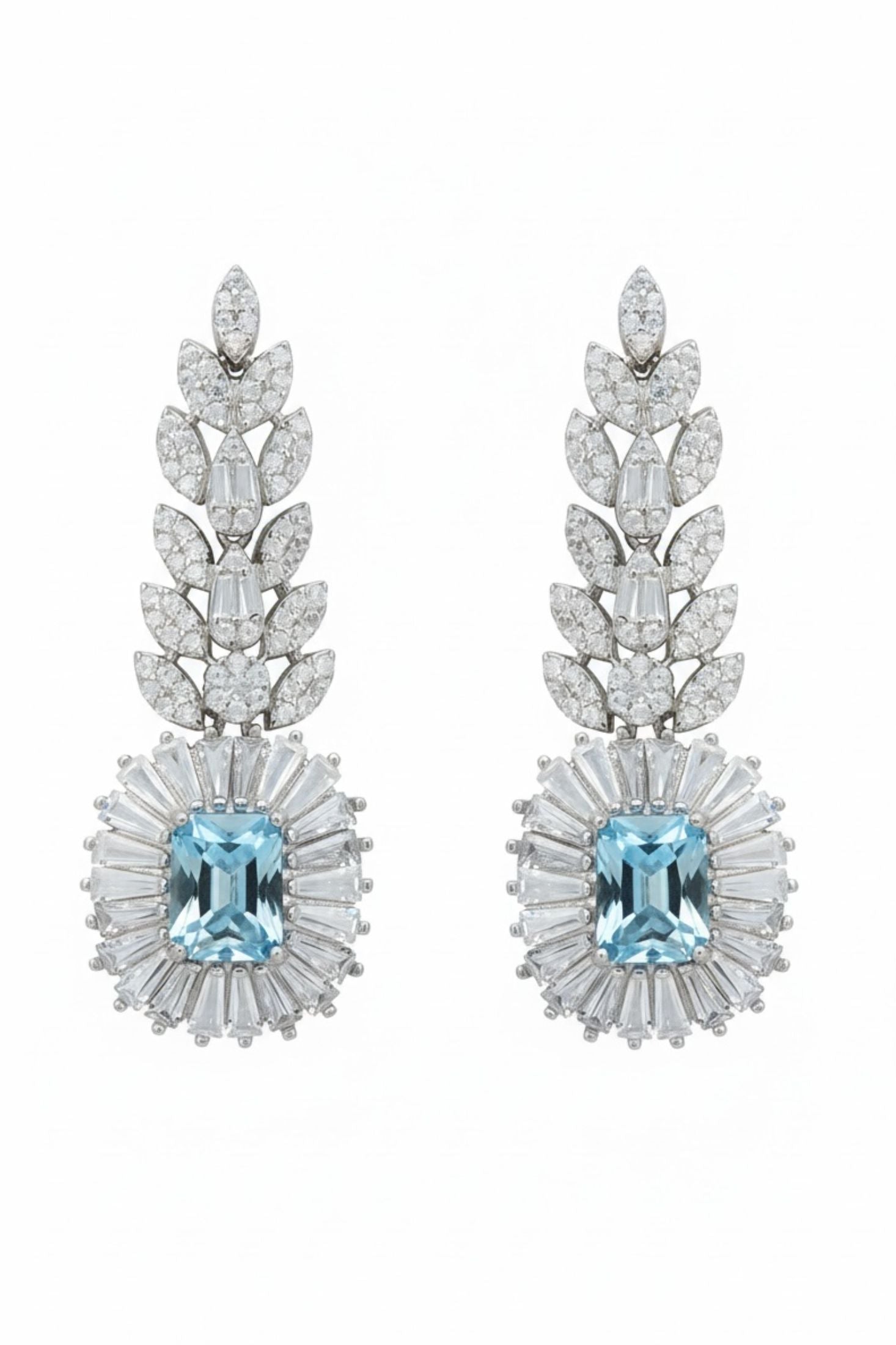 Pair of earrings with blue gemstones and diamond-studded designs on a white background