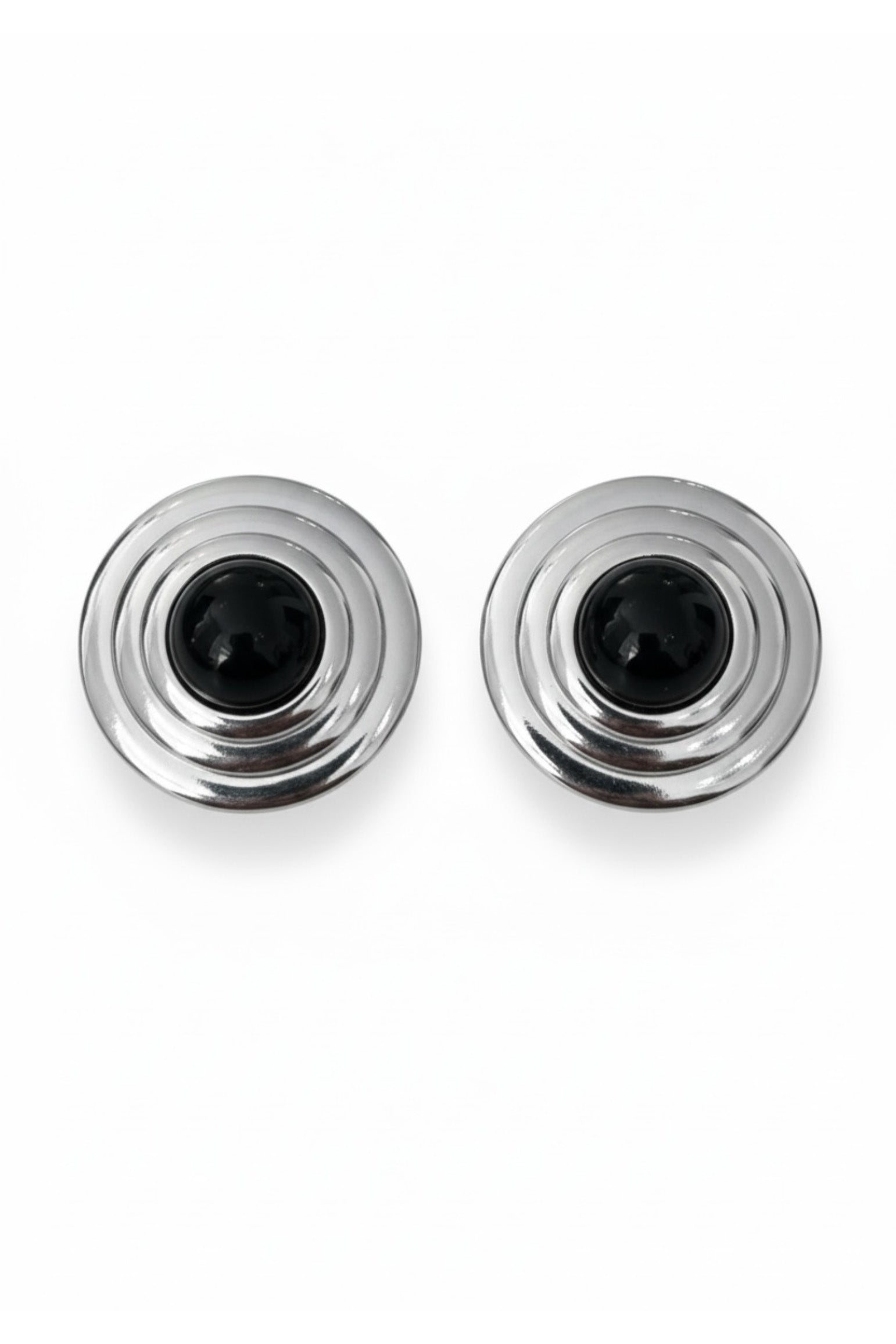 Silver earrings with a black centre on a white background