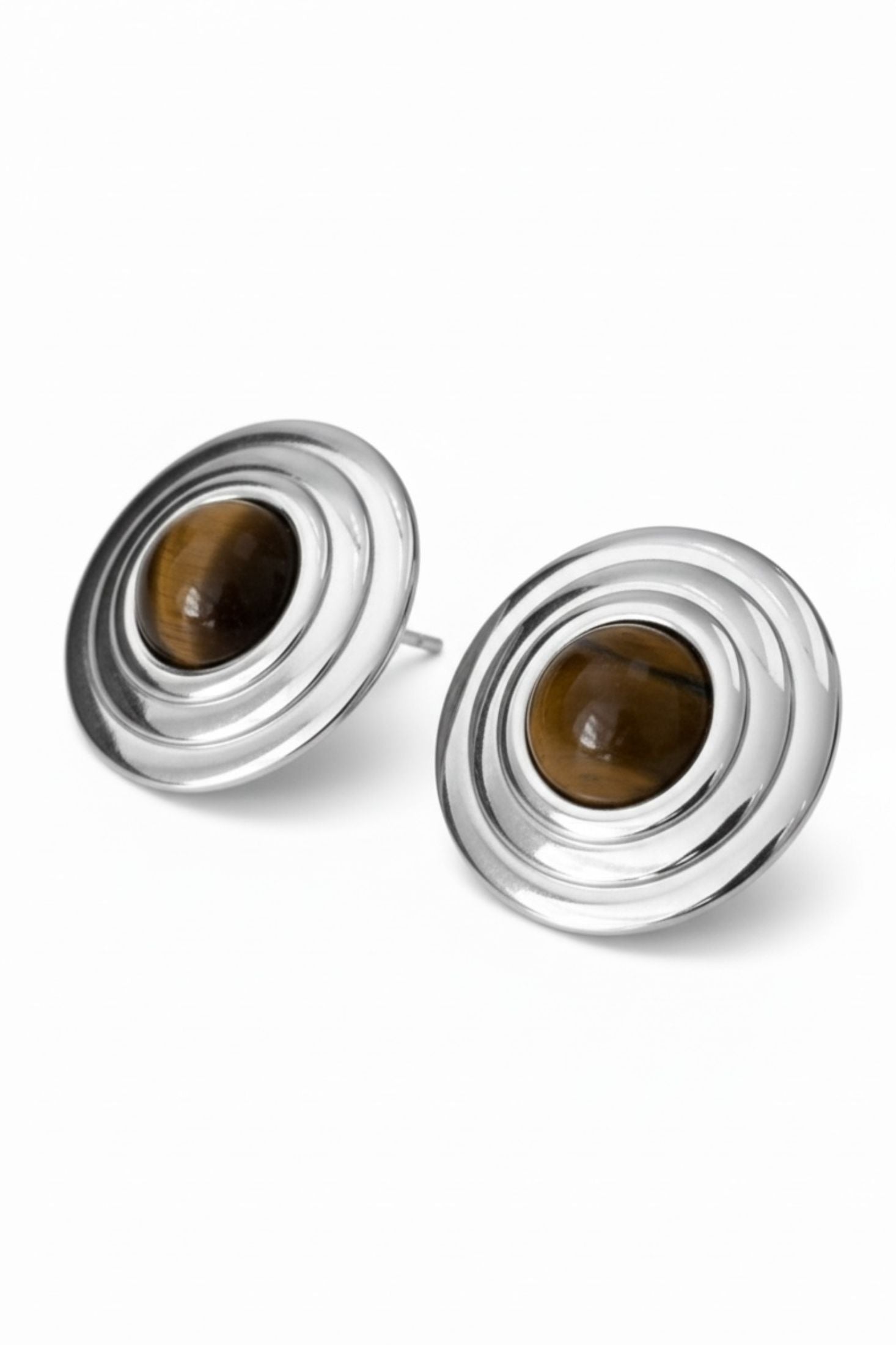 Pair of silver earrings with brown gemstones on a white background