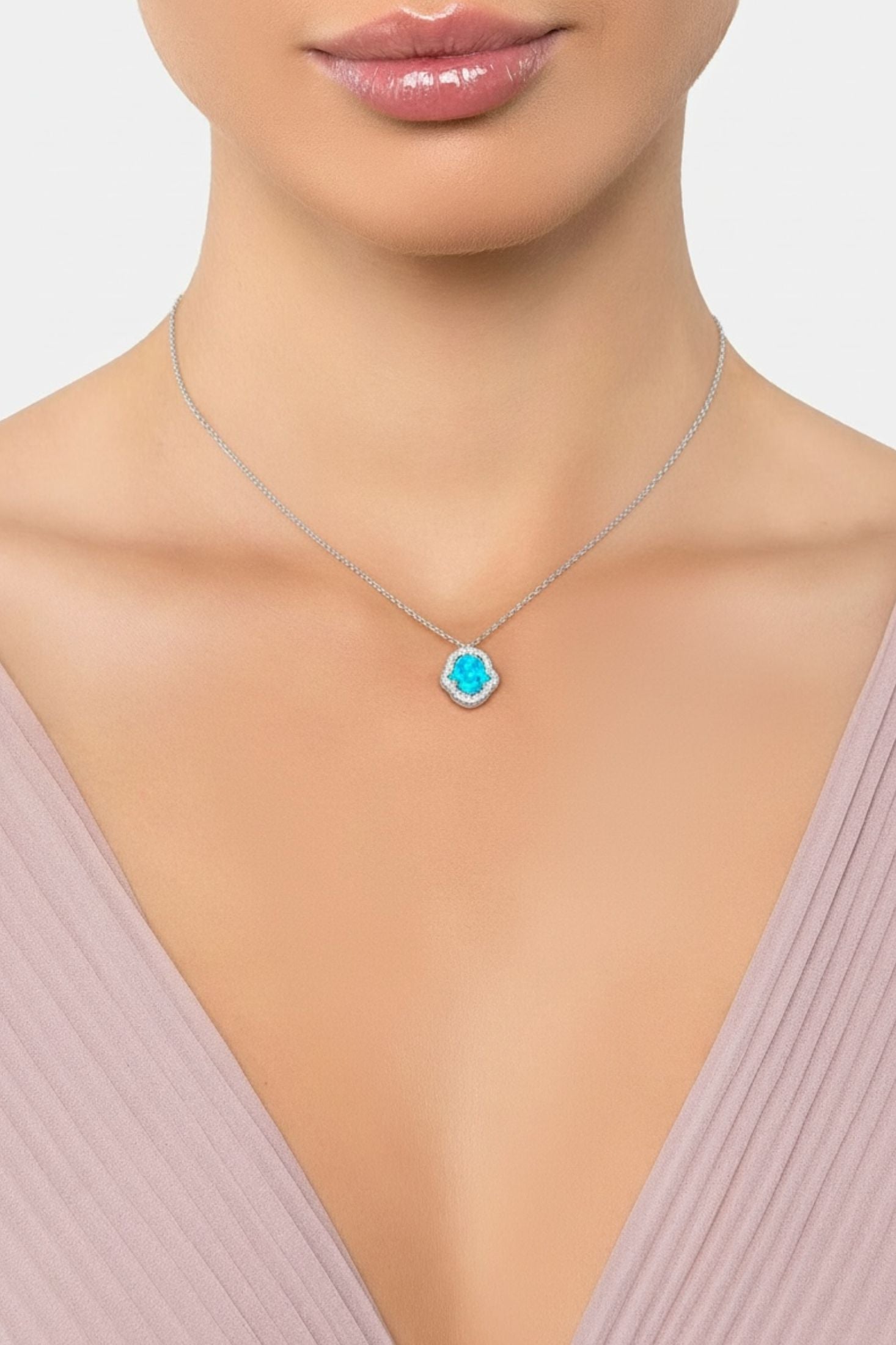 Necklace with a blue pendant worn by a model on a plain background