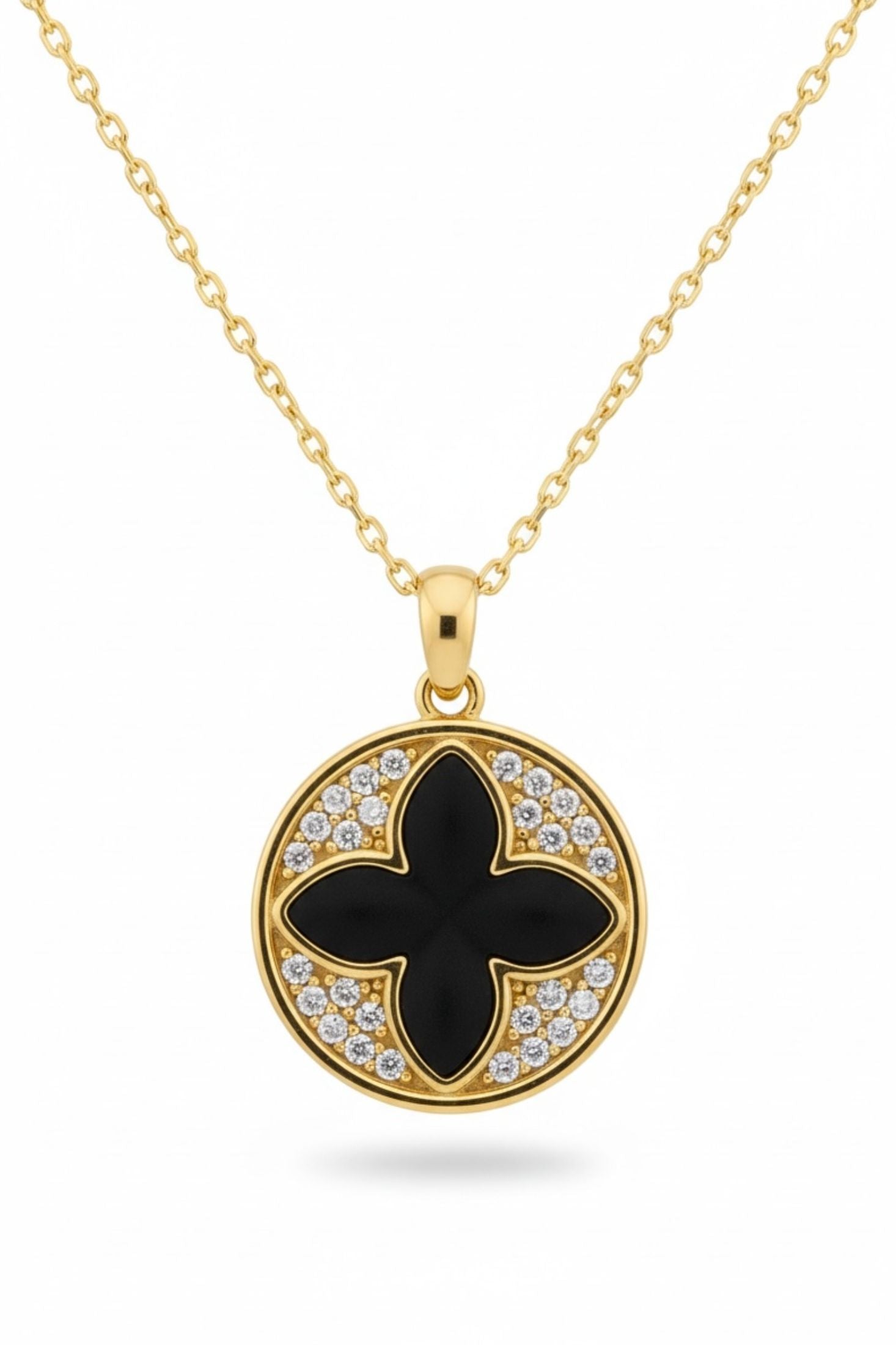 Gold necklace with a black clover pendant and diamond accents on a white background