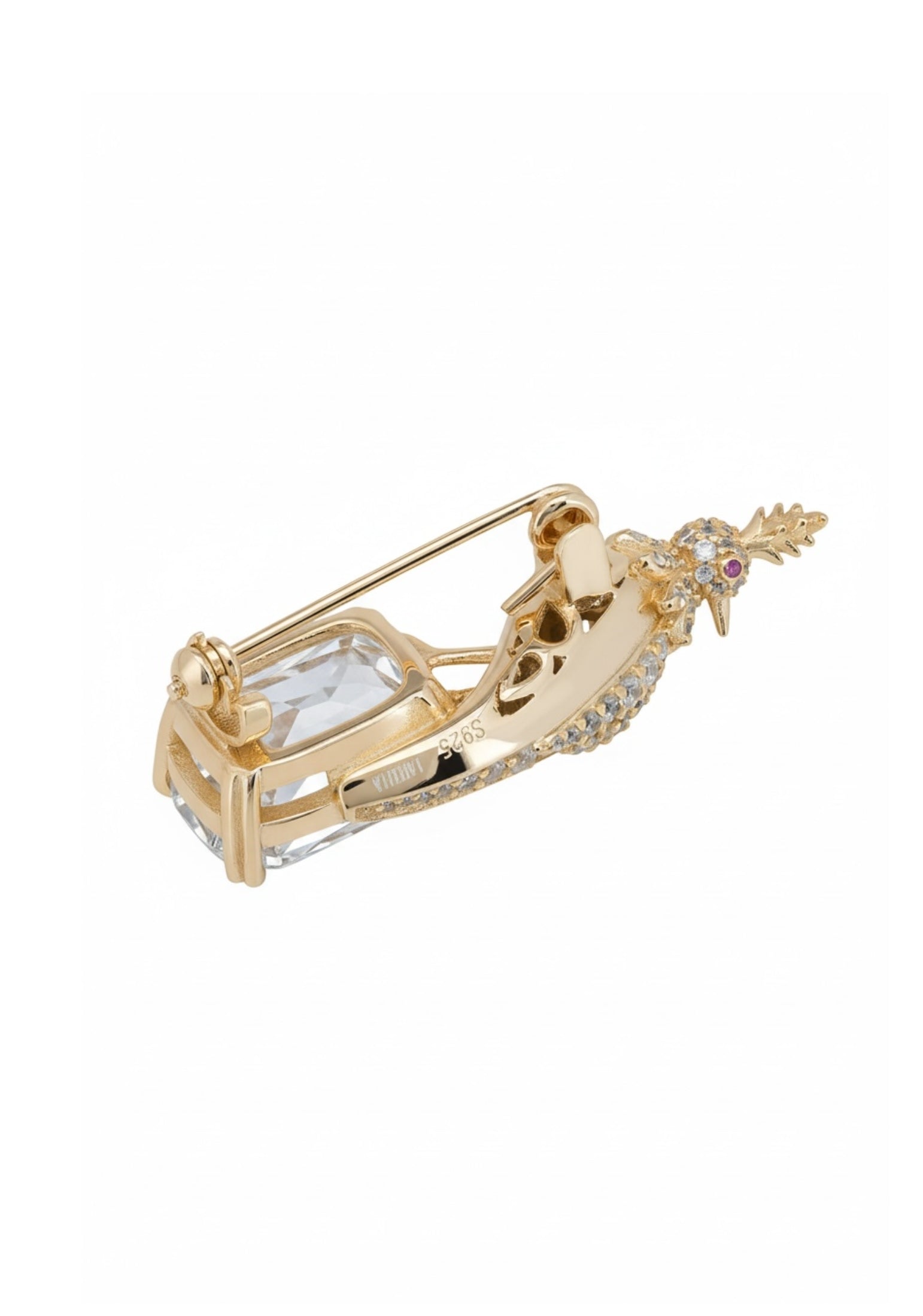 Gold brooch with a decorative bird on a white background