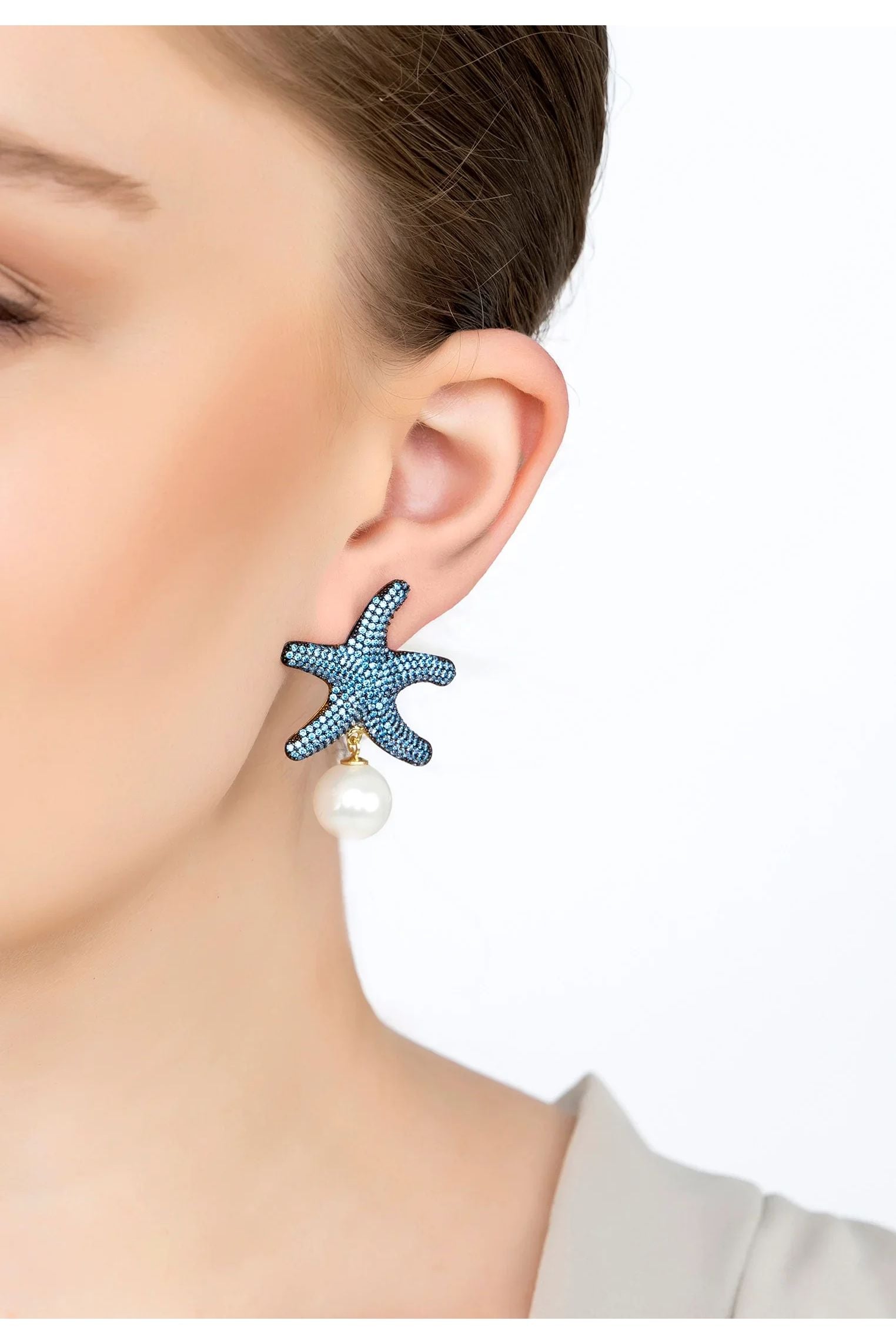 The earring worn by a model.