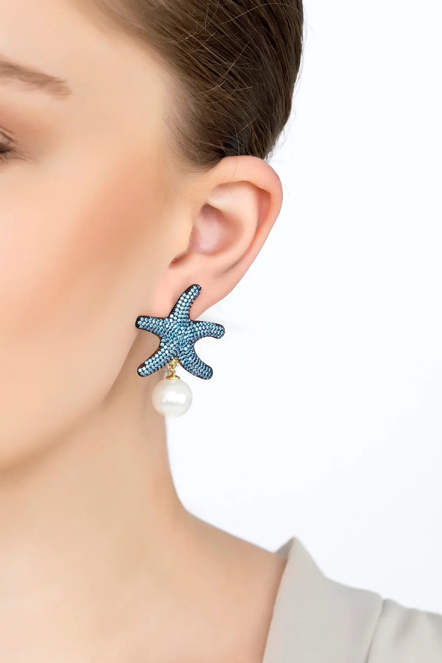 The earring worn by a model.