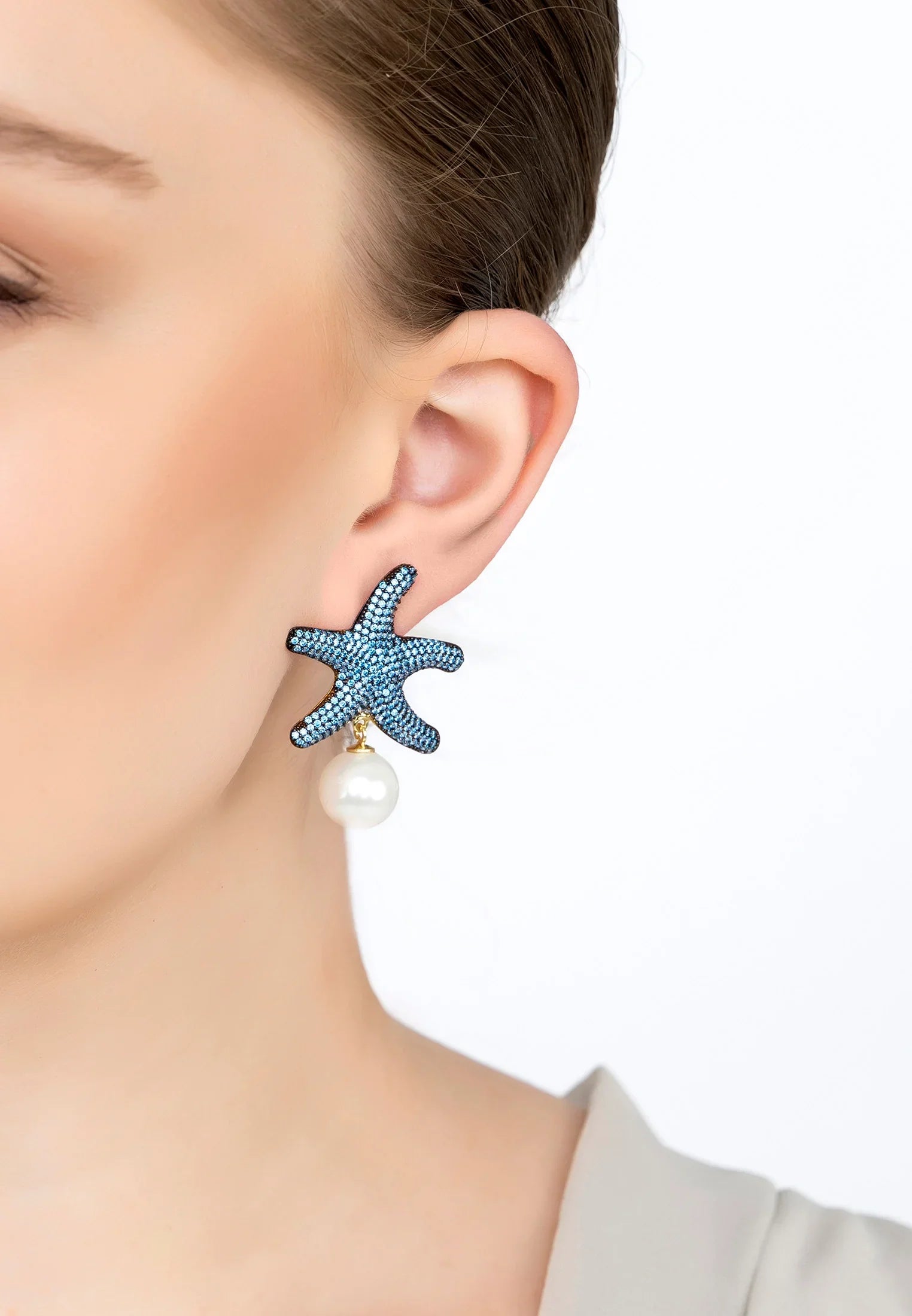 The earring worn by a model.