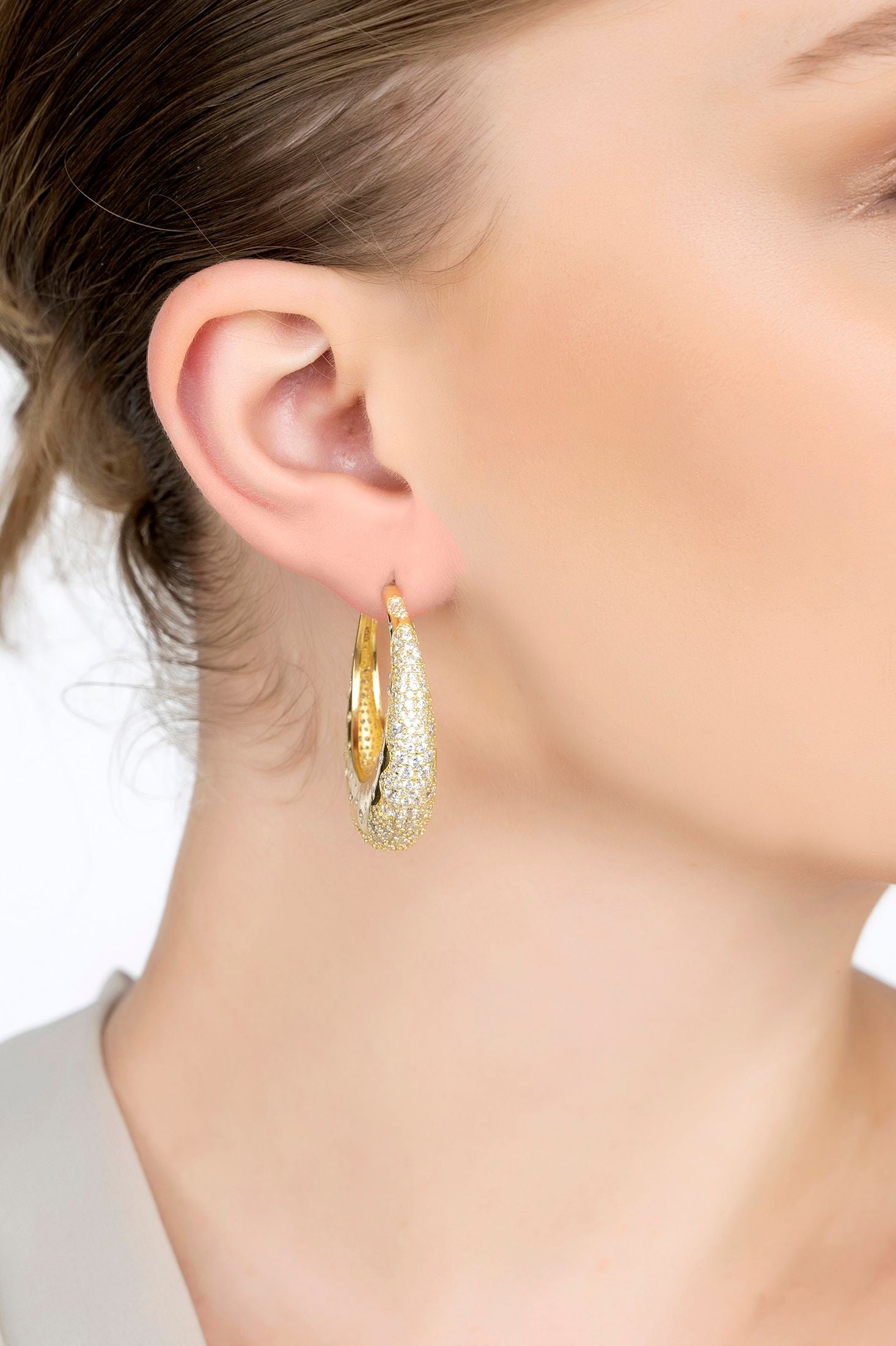 The earring worn by a model.