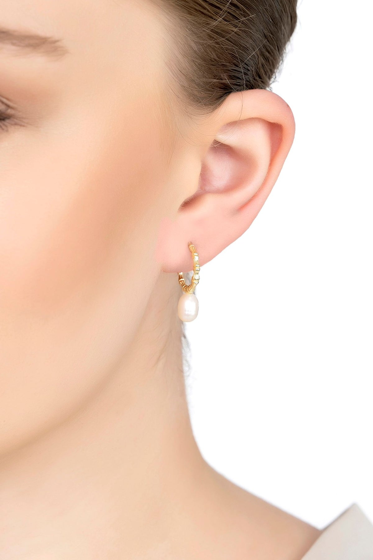 The earring worn by a model.