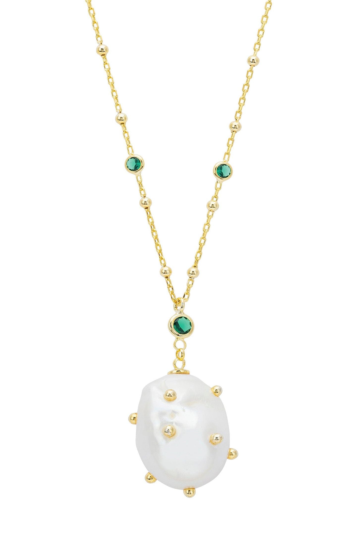 Gold necklace with a large white pearl pendant and smaller green gemstones on a white background