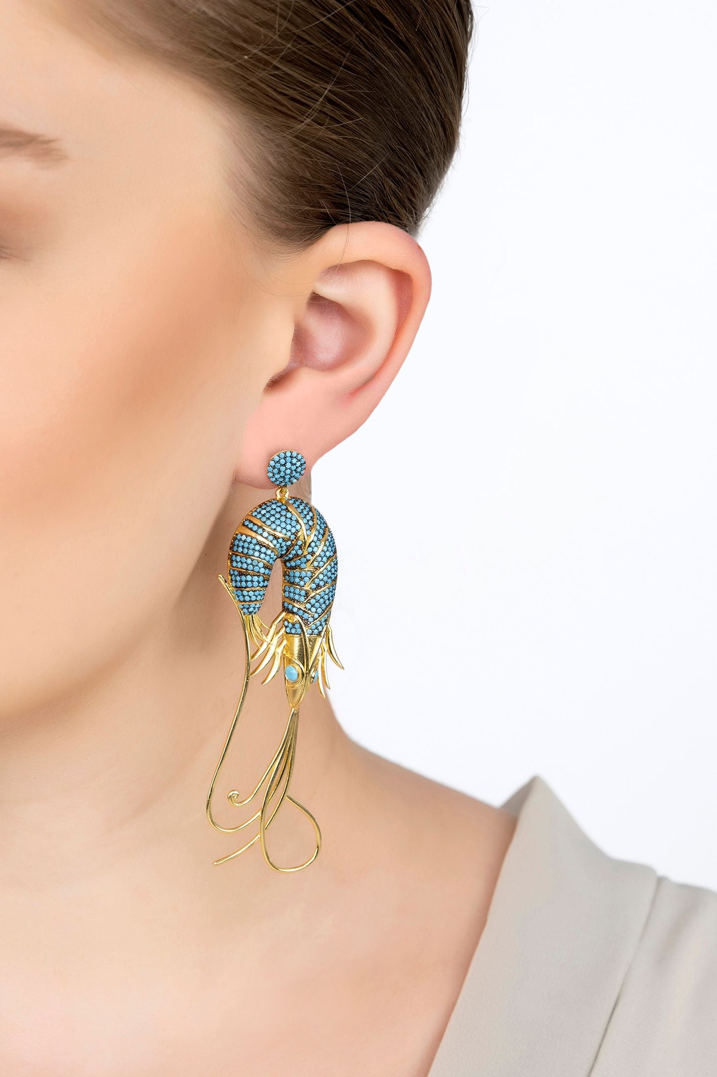 The earring worn by a model.
