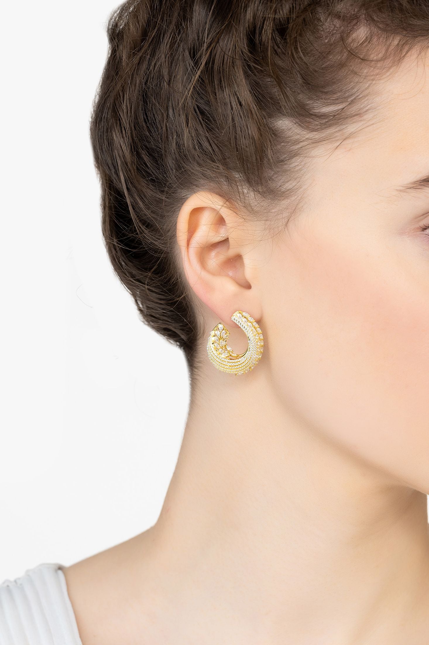 Angled view of Artemis Sweeping Hoop Earrings Gold, showing gold finish and the jewellery profile.