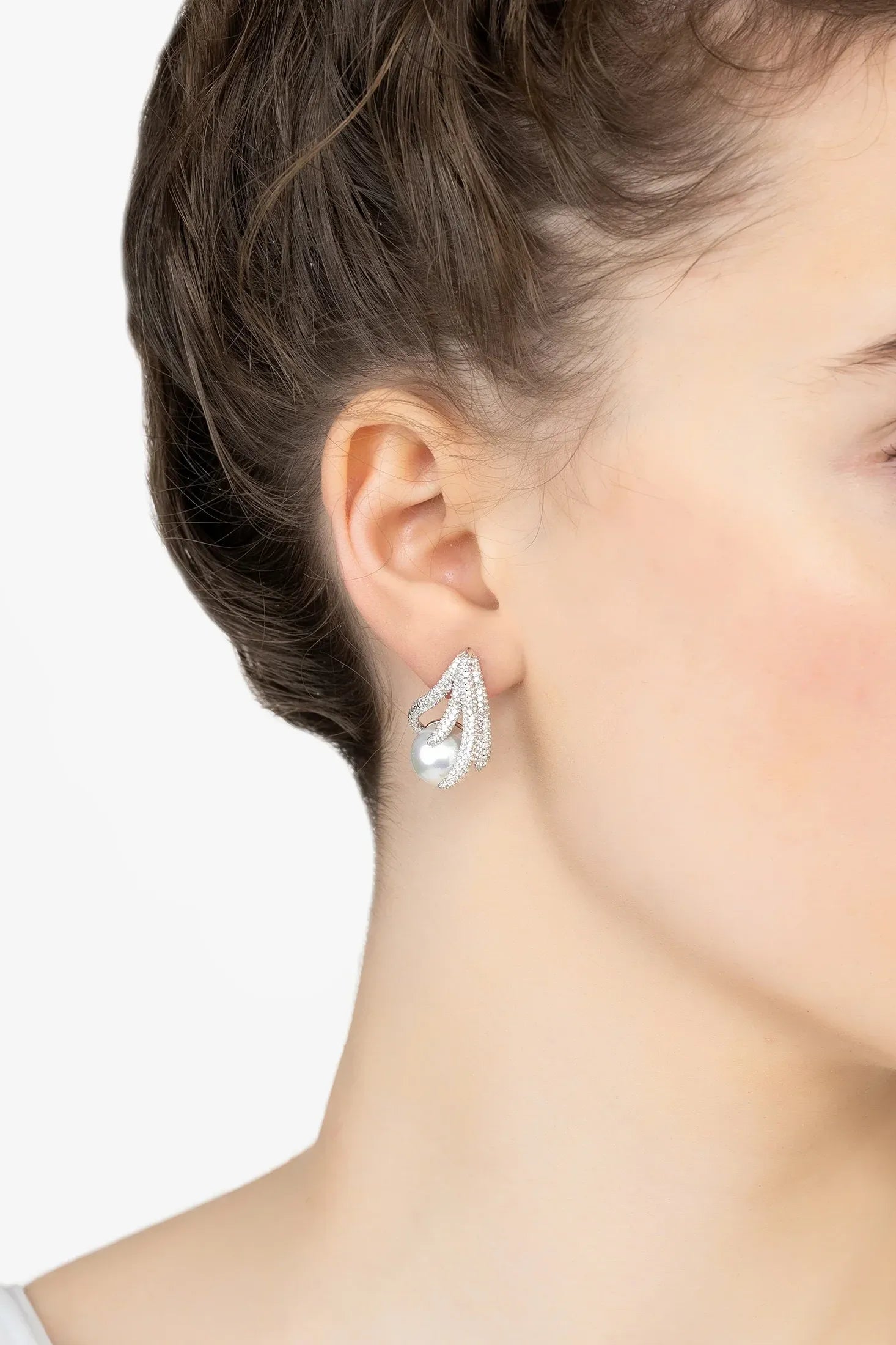 Angled view of Moonlit Embrace Pearl Earrings Silver, showing moon design, pearl detailing, silver finish and the jewellery profile.