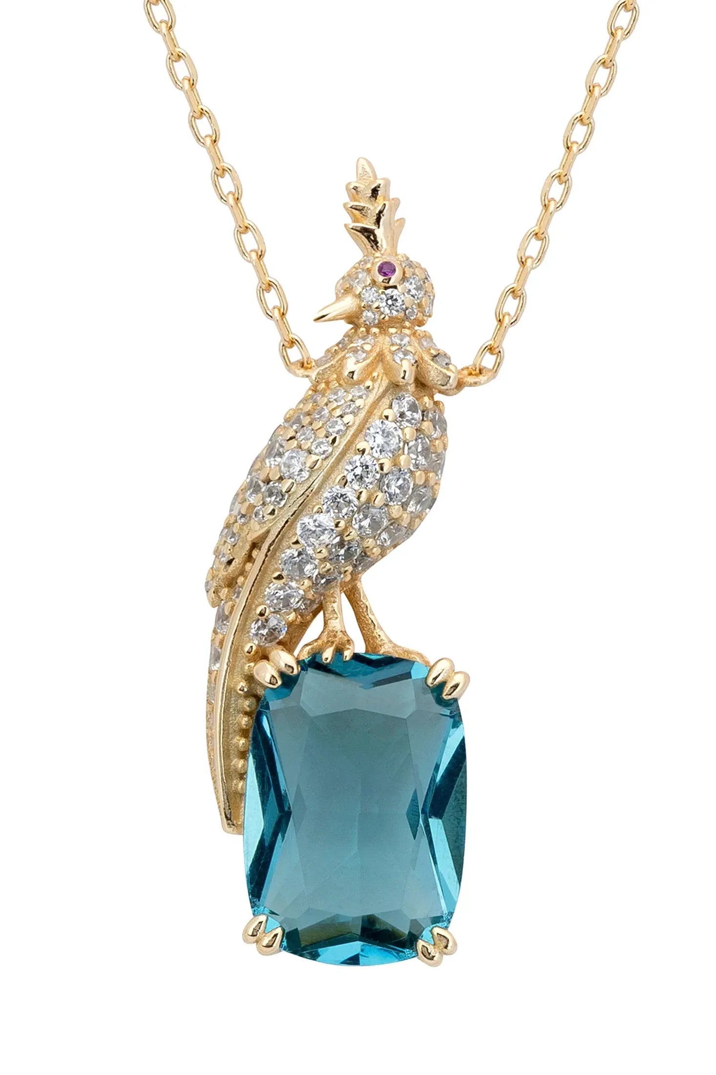 Close-up of the diamond and gold bird perched on a blue gemstone charm.
