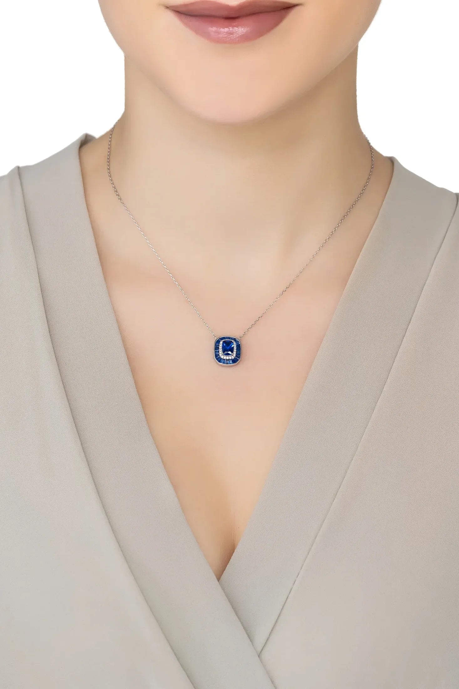 Angled view of Great Gatsby Pendant Necklace Sapphire Silver, showing sapphire detailing, silver finish and the jewellery profile.