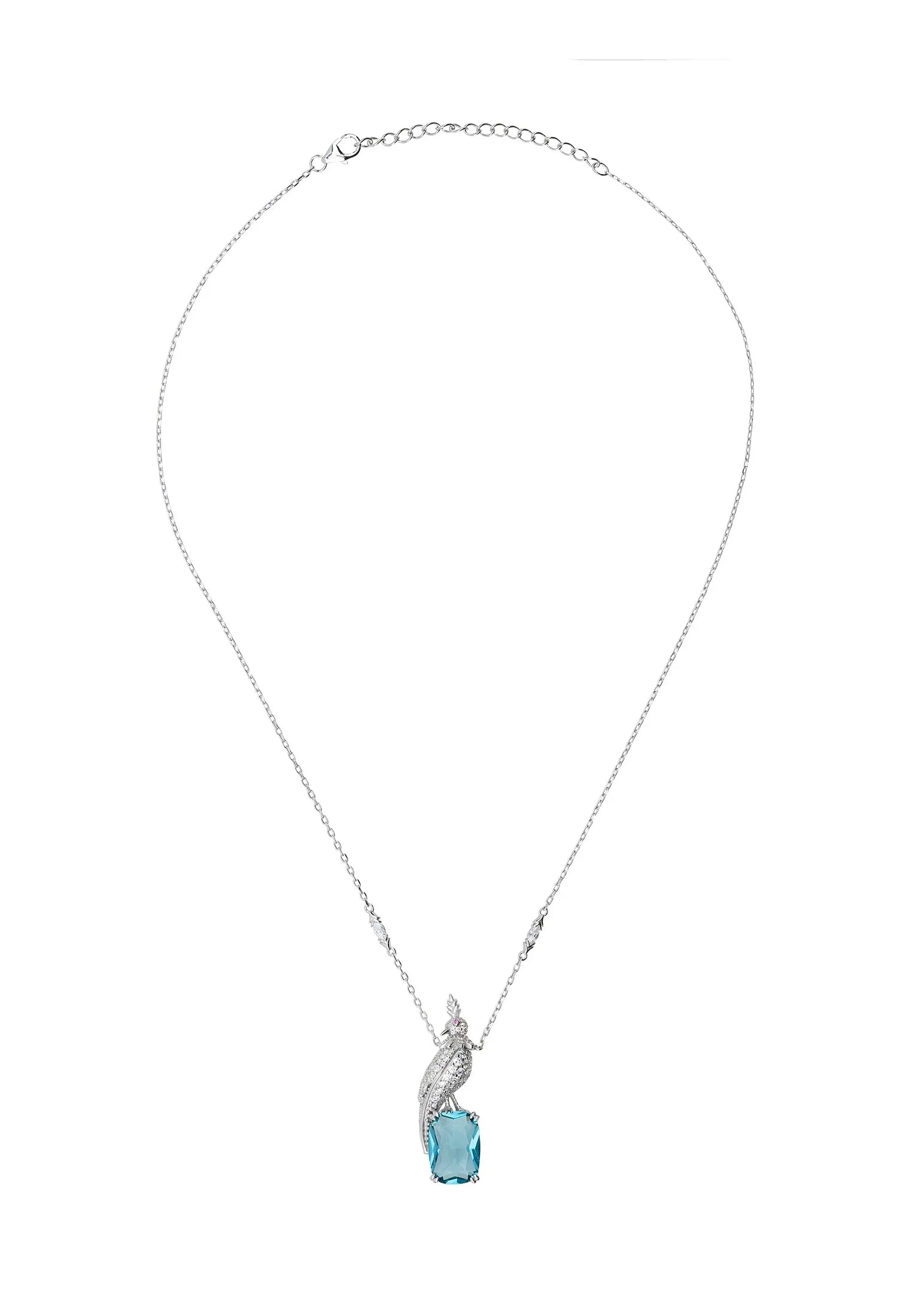 Diamond bird perched on a blue gemstone, a silver charm necklace.