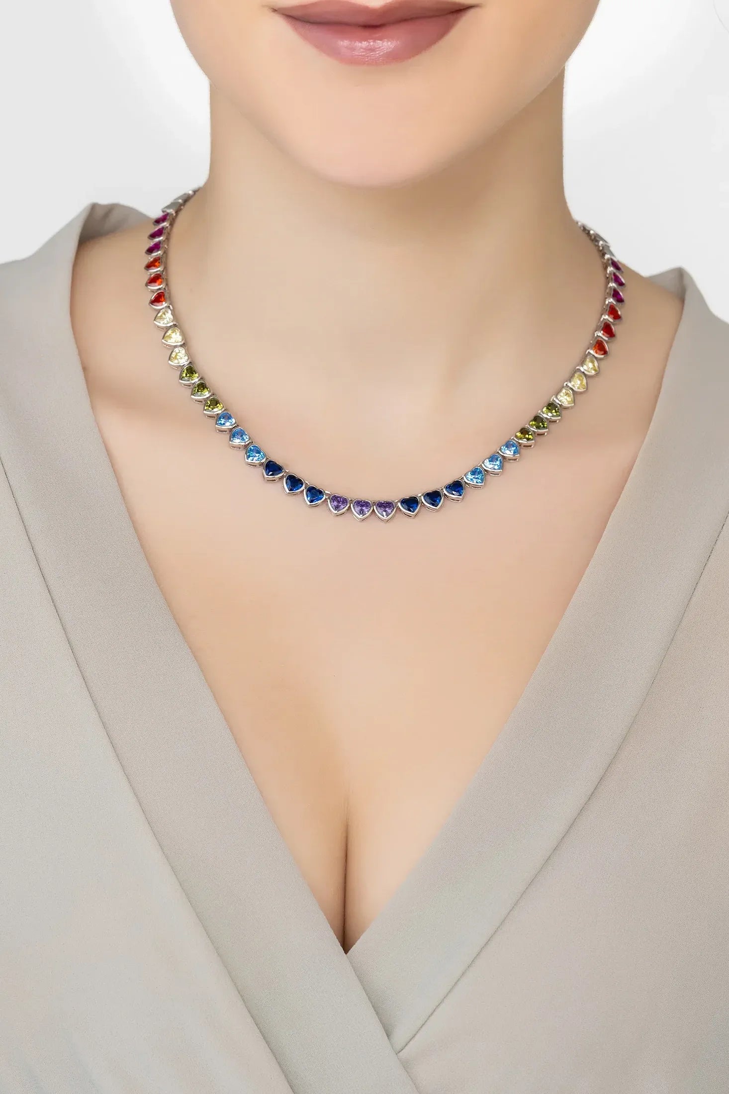 Angled view of Heart Garland Rainbow Gemstone Necklace Silver, showing heart design, silver finish and the jewellery profile.
