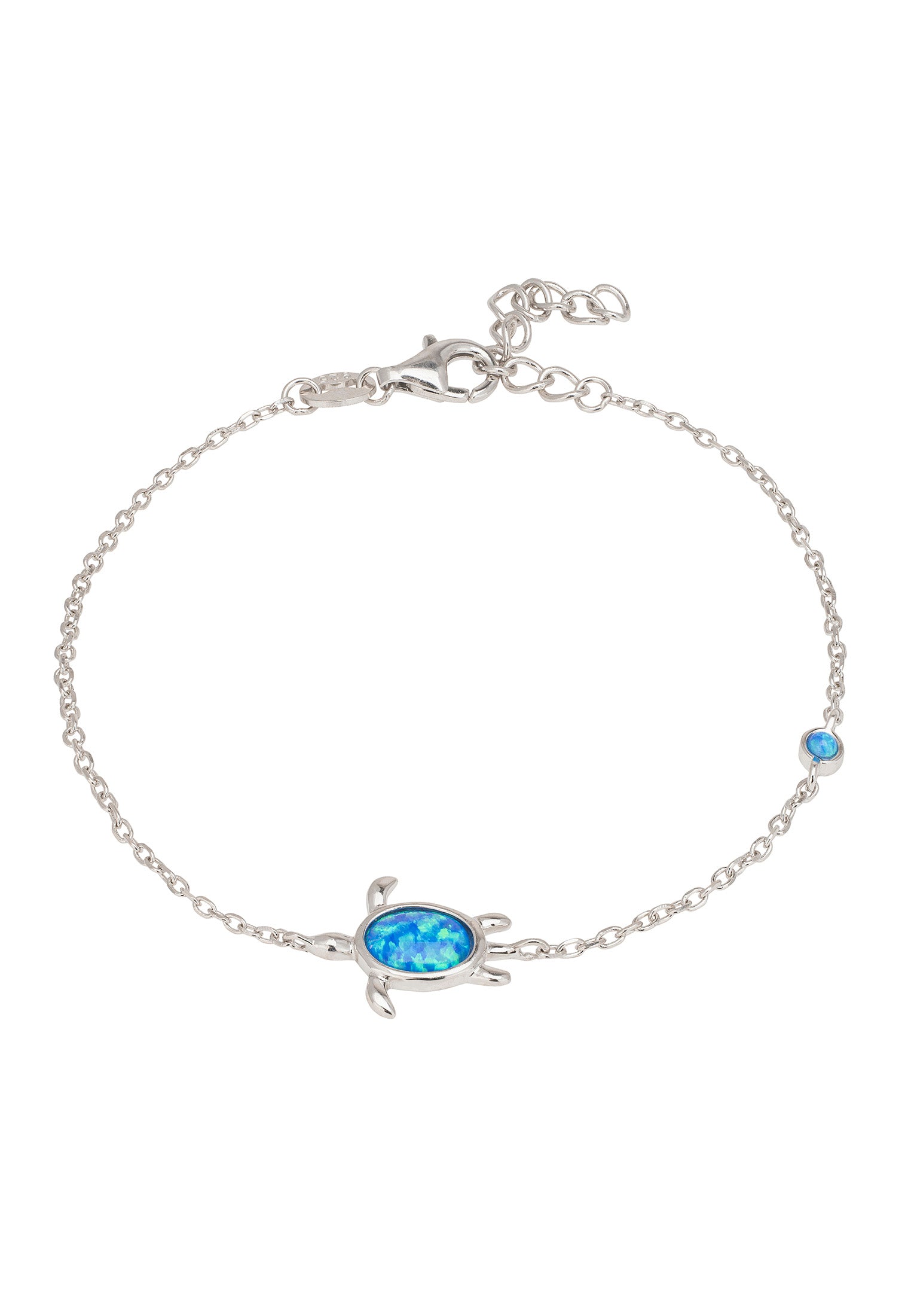 Silver turtle bracelet with blue gem on a white background