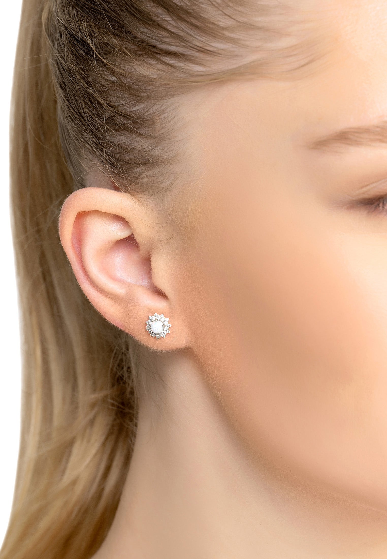 The earring worn by a woman.