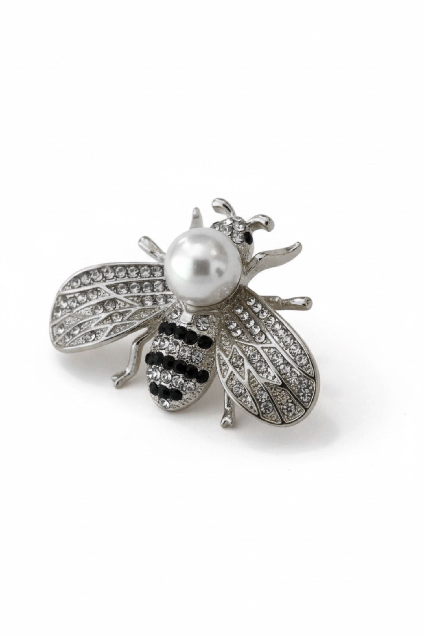 Bee-shaped brooch with pearl and black gemstones on a white background