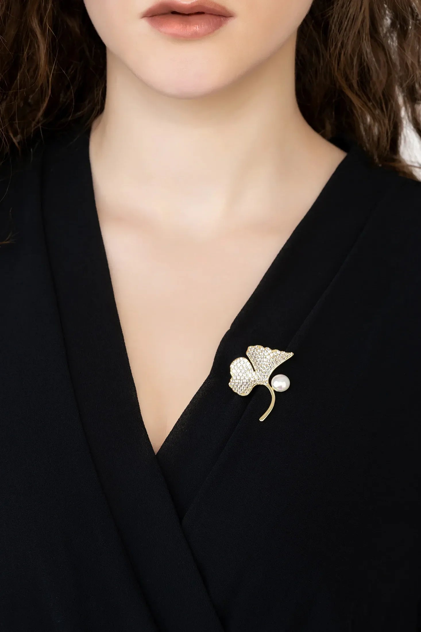 Angled view of Ginkgo Leaf And Pearl Brooch Gold, showing leaf design, pearl detailing, gold finish and the jewellery profile.