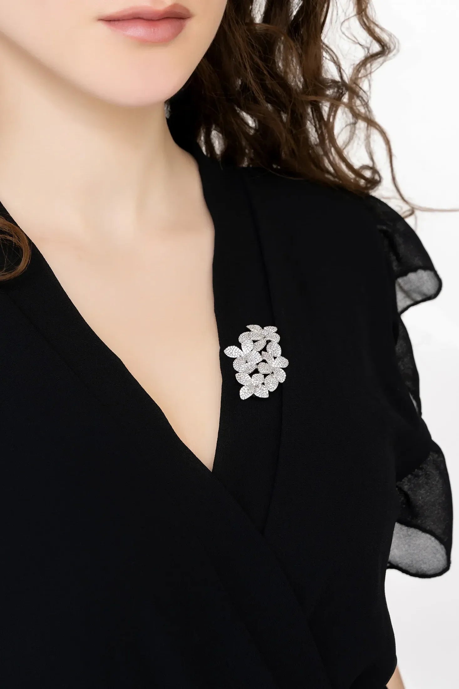Angled view of Petal Cascading Flower Brooch Silver, showing flower design, silver finish and the jewellery profile.