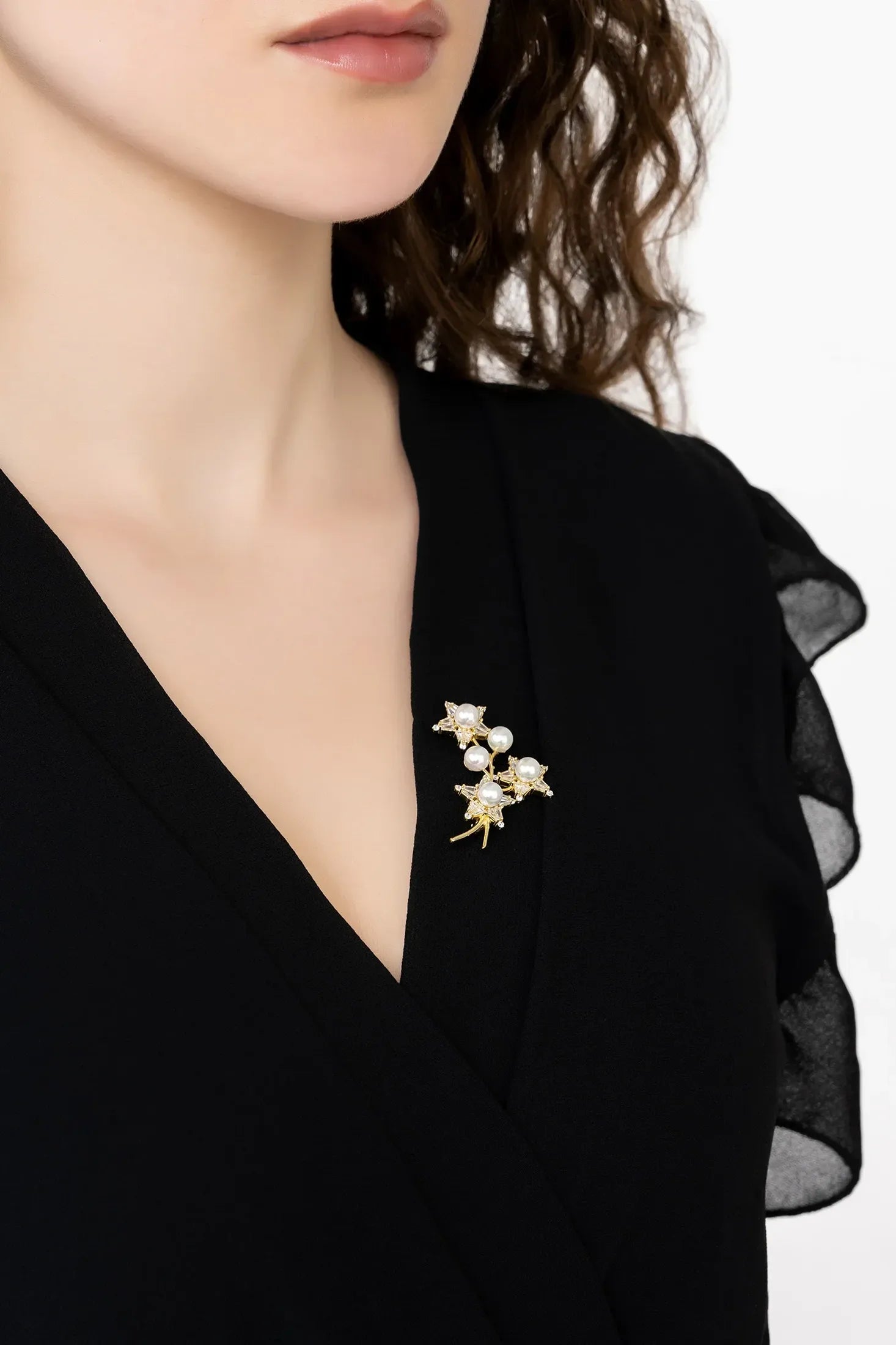 Angled view of Starry Night Pearl Brooch Gold, showing star design, pearl detailing, gold finish and the jewellery profile.