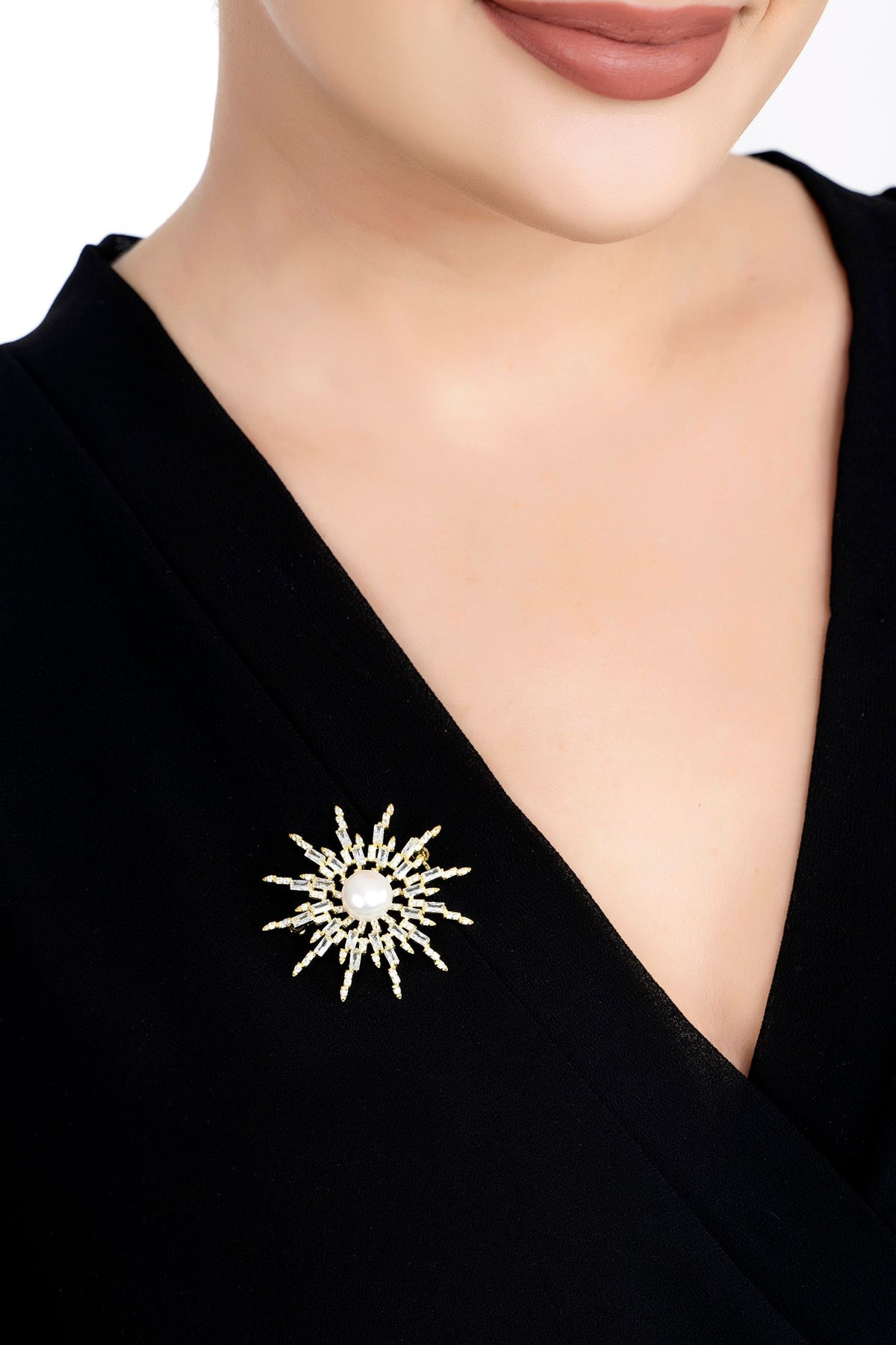 The brooch worn by a model.
