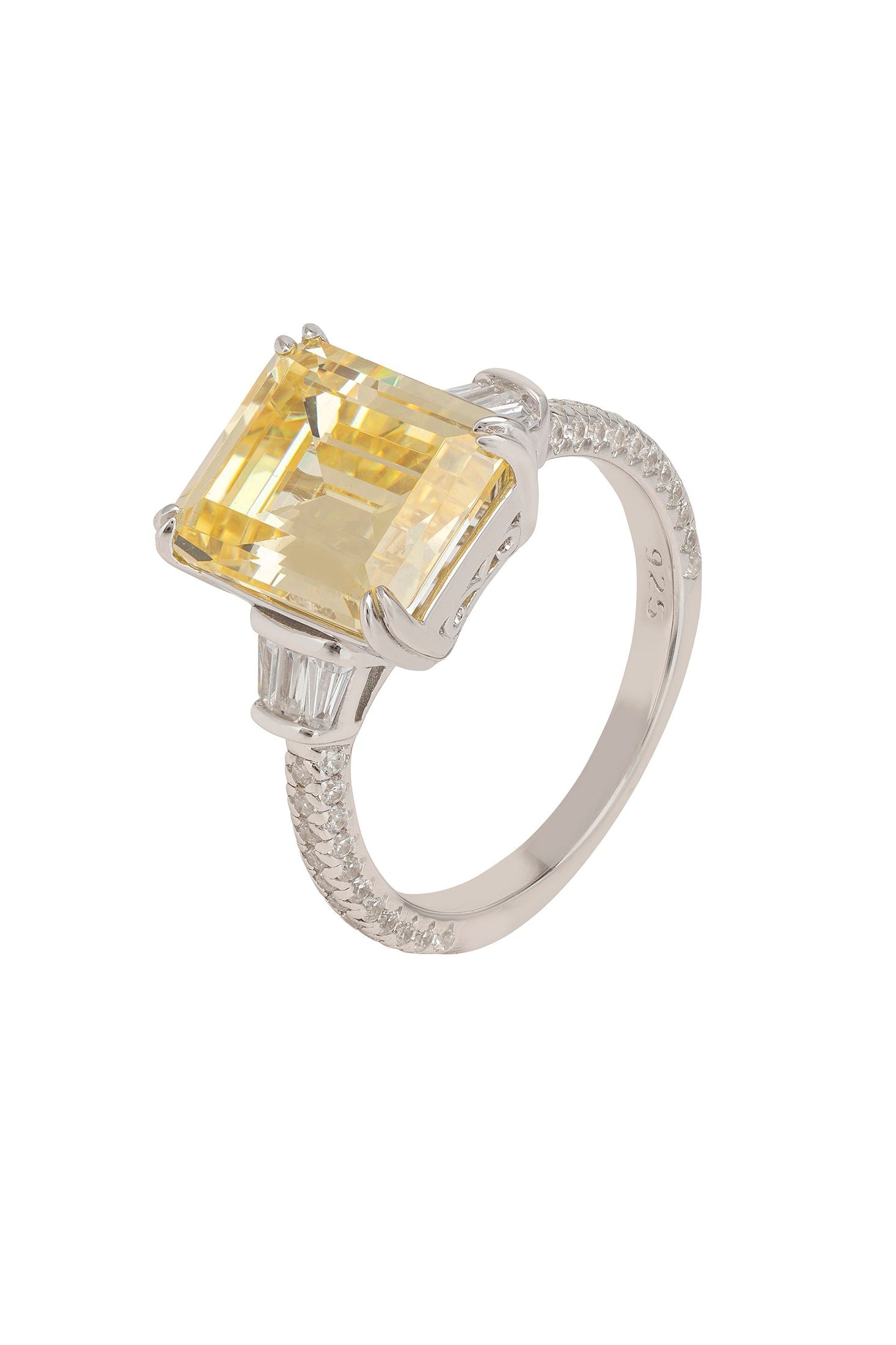 Ring with a yellow gemstone and silver band on a white background