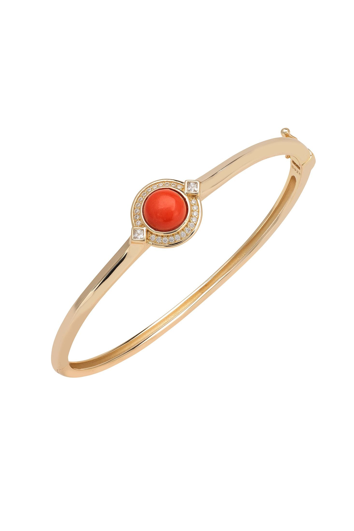 Gold bracelet with a red gemstone on a white background