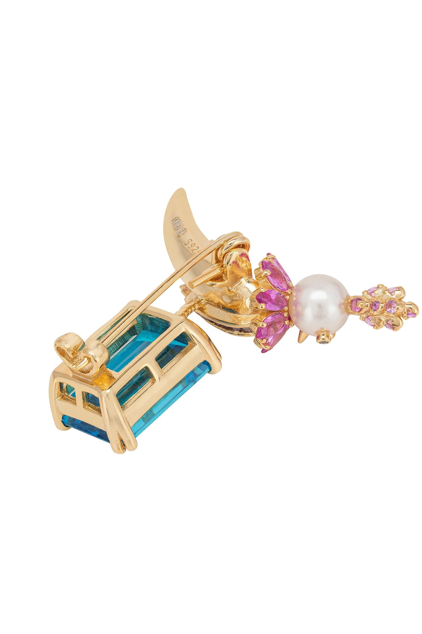 Gold brooch with gemstones on a white background