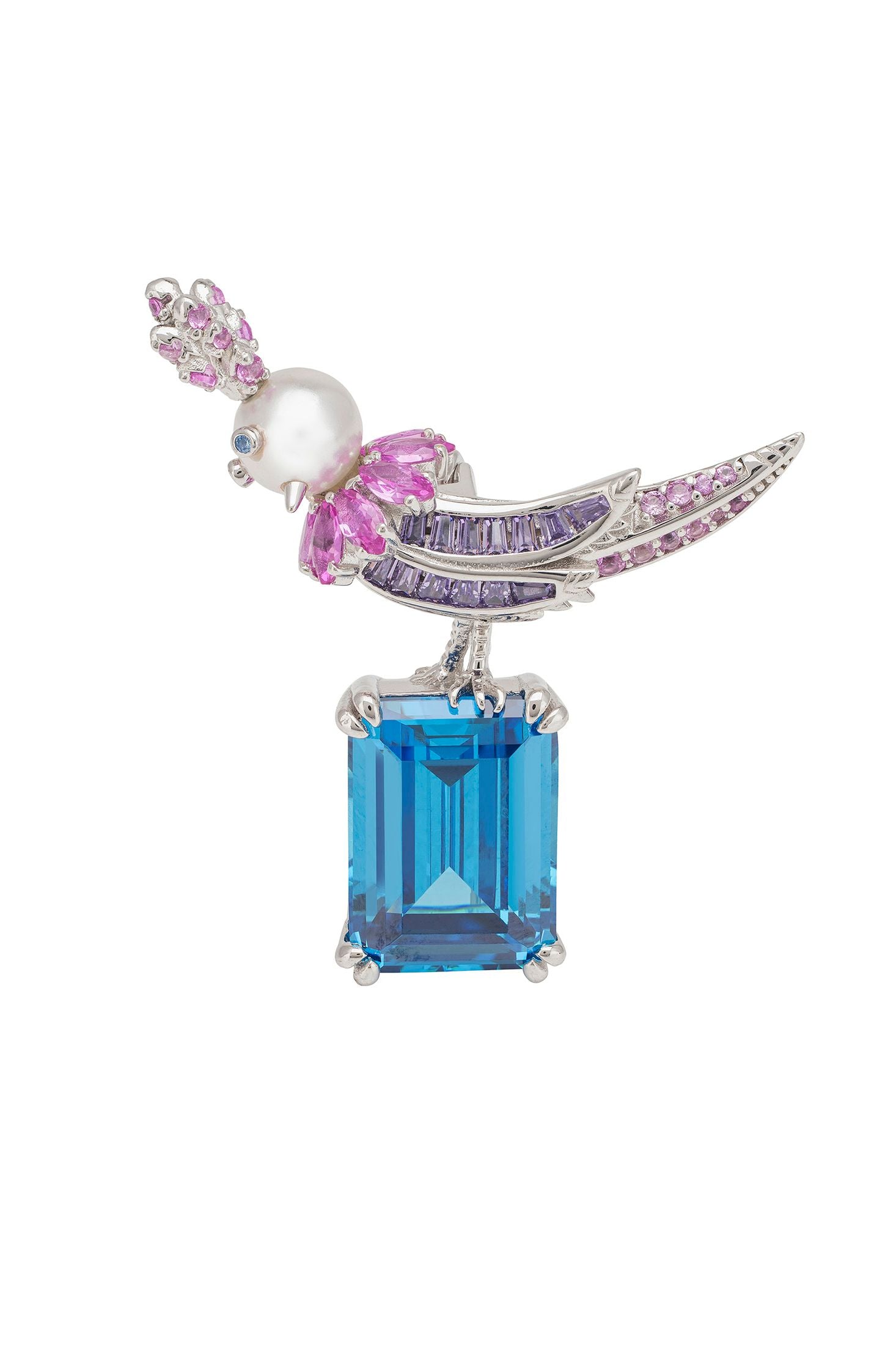 Bird shaped brooch with blue gemstone, pink sapphire gemstones, and pearl on a white background