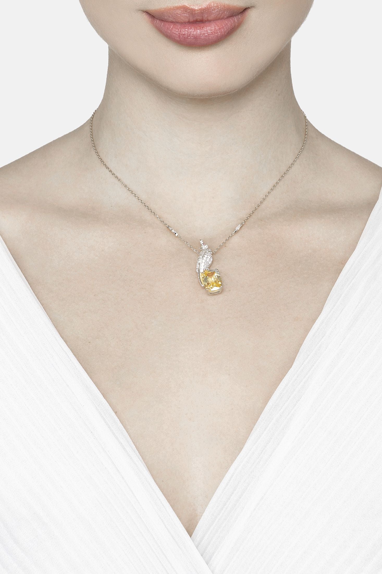 Angled view of Crested Love Bird Pendant Necklace Yellow Topaz Silver, showing bird design, silver finish and the jewellery profile.