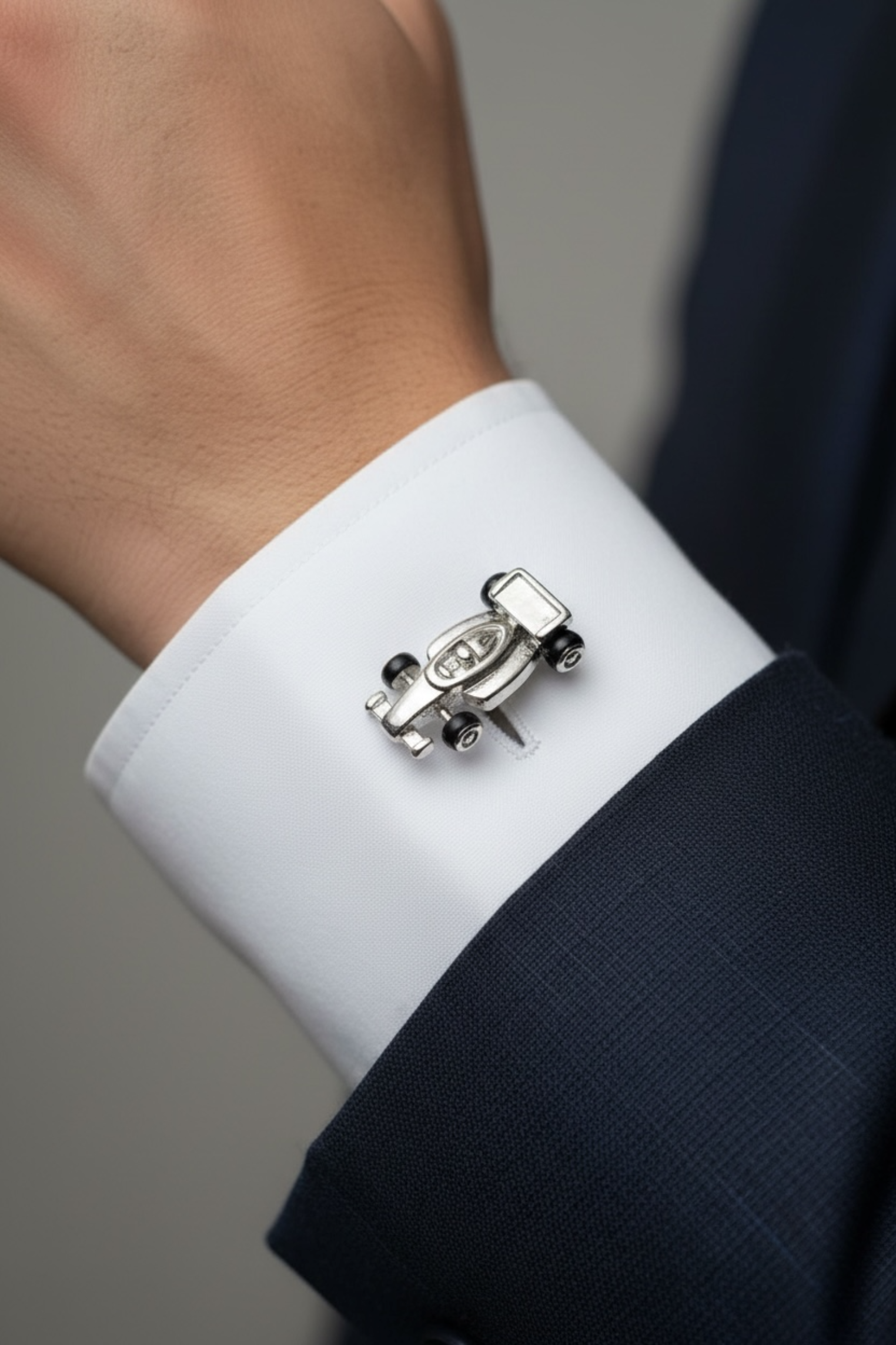 Close-up of the cufflink on a model wearing a suit.