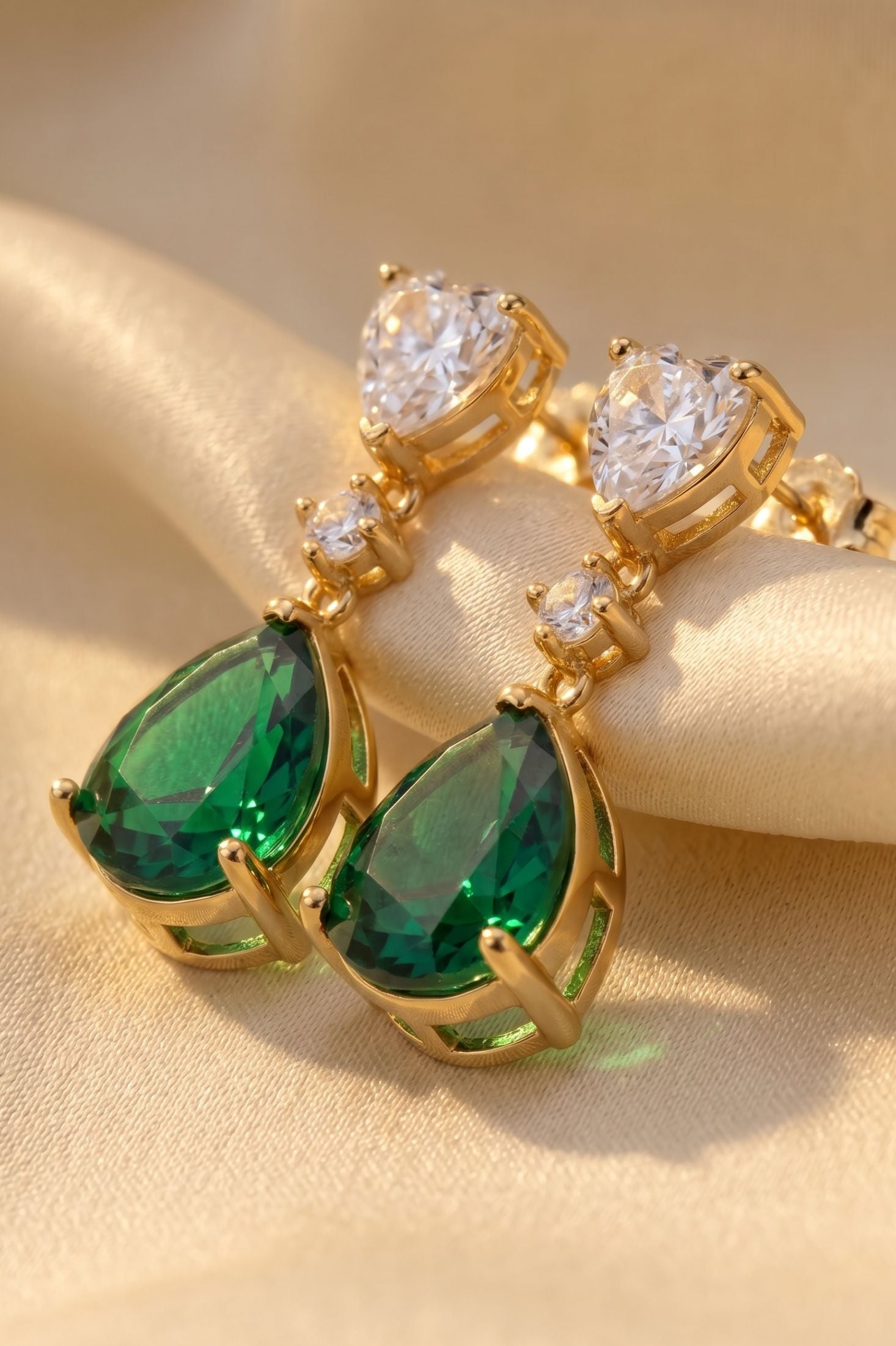 Angled view of Irina Paraiba Tourmaline Teardrop Earrings Gold, showing gold finish and the jewellery profile.