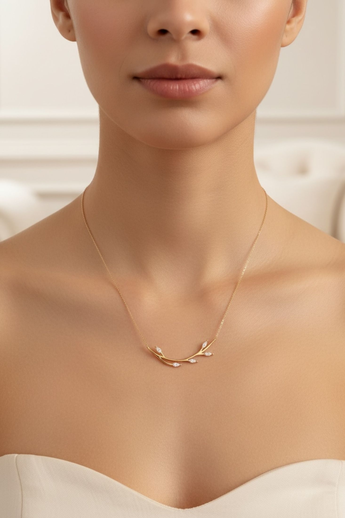 Close-up of a person wearing a delicate gold necklace against a neutral background