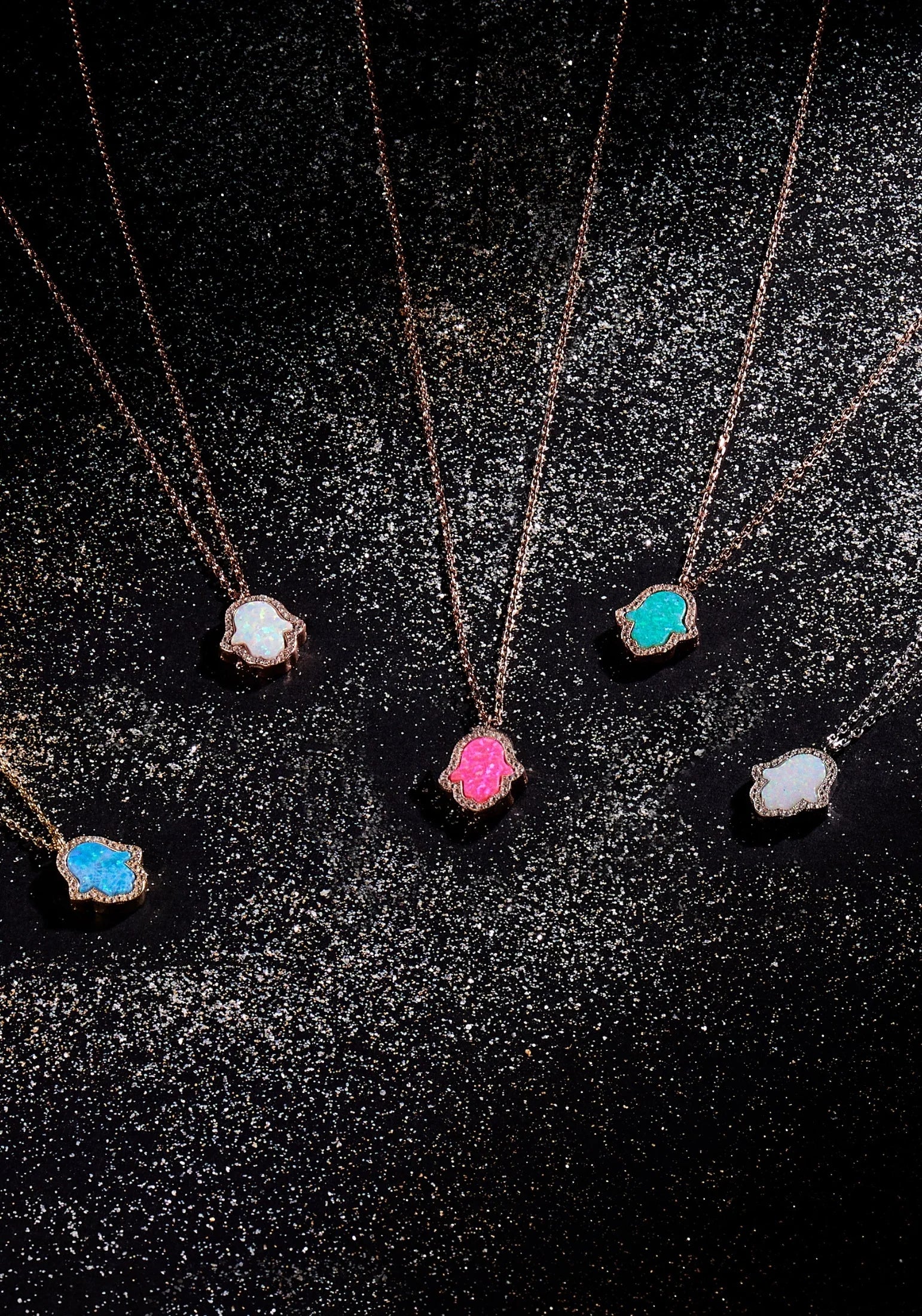 Hamsa hand necklaces with different opal and metal variants.