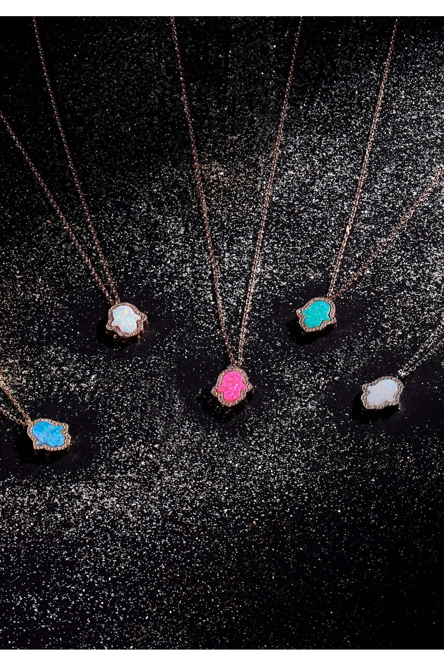 Hamsa hand necklaces with different opal and metal variants.