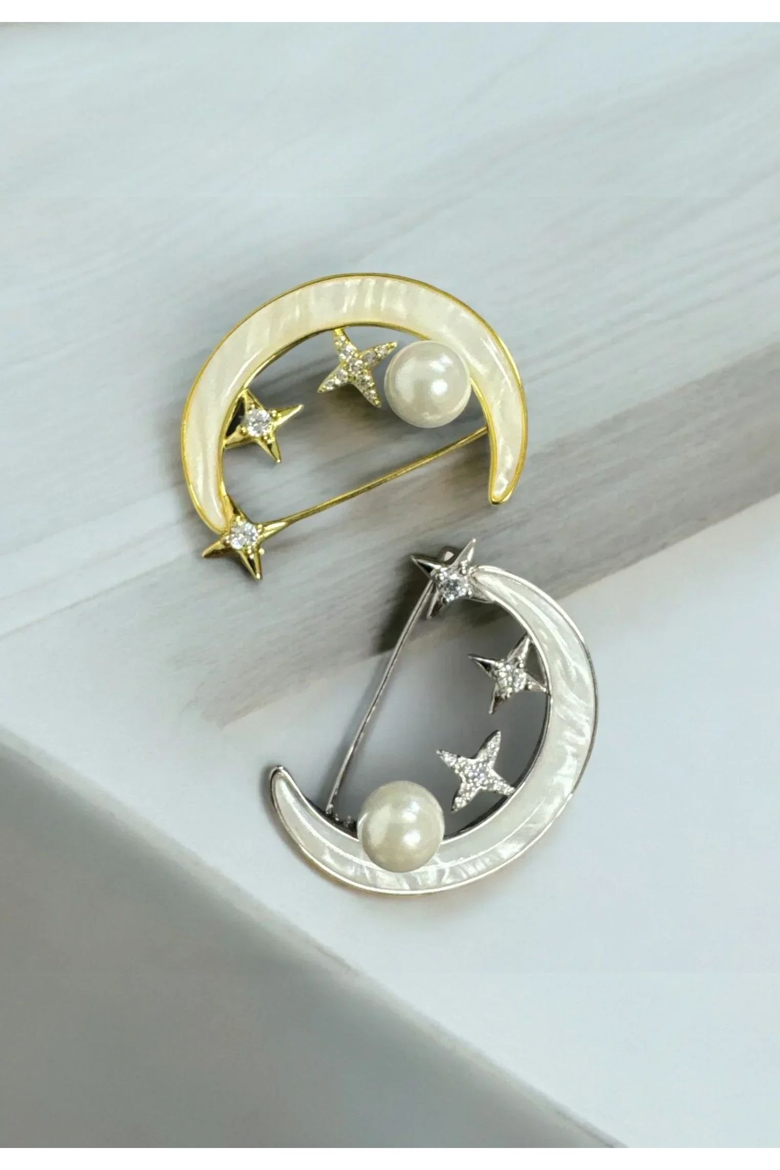 Still life of the gold and silver variation of the pins.