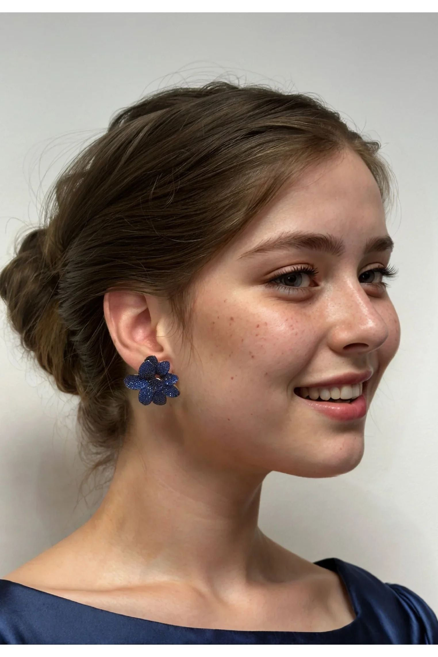 The earring worn by a model.