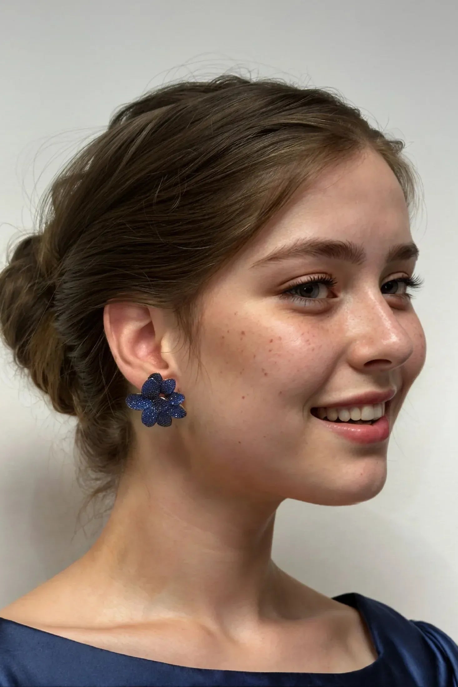 The earring worn by a model.