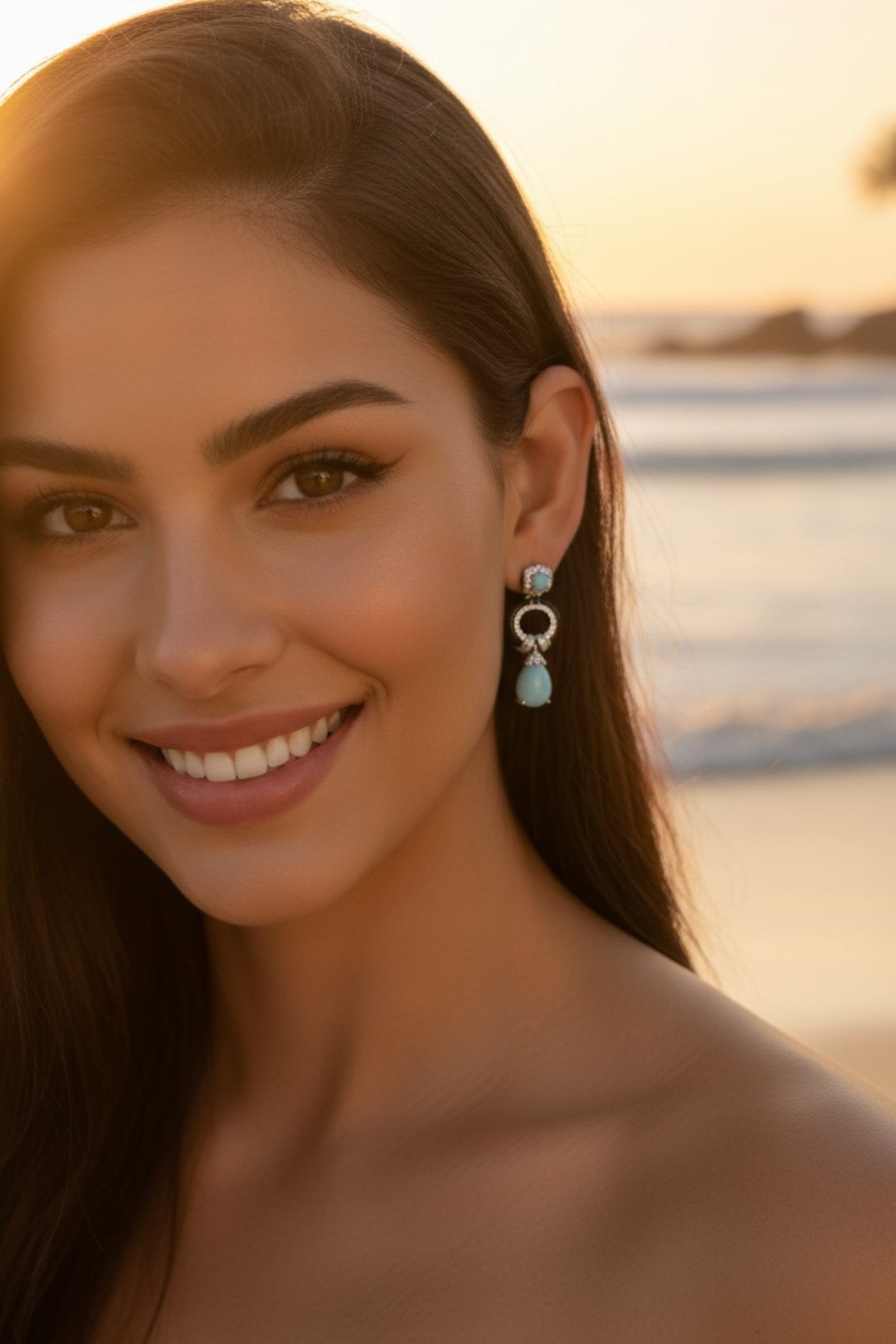 The earring worn by a model on a beach.