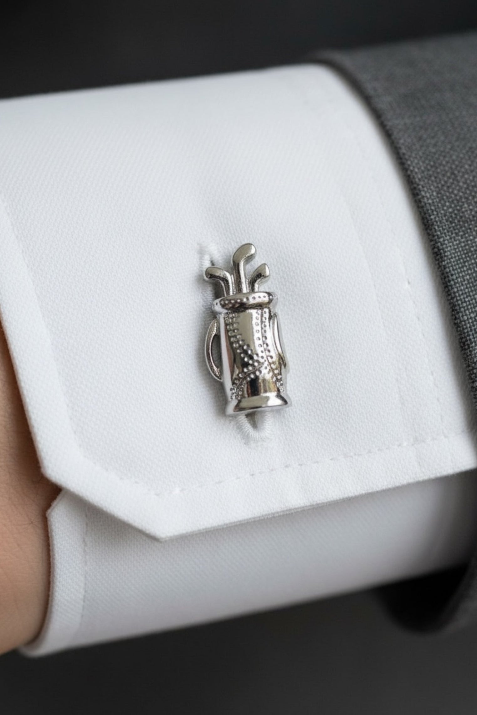 Close-up of the cufflink on a model wearing a suit.